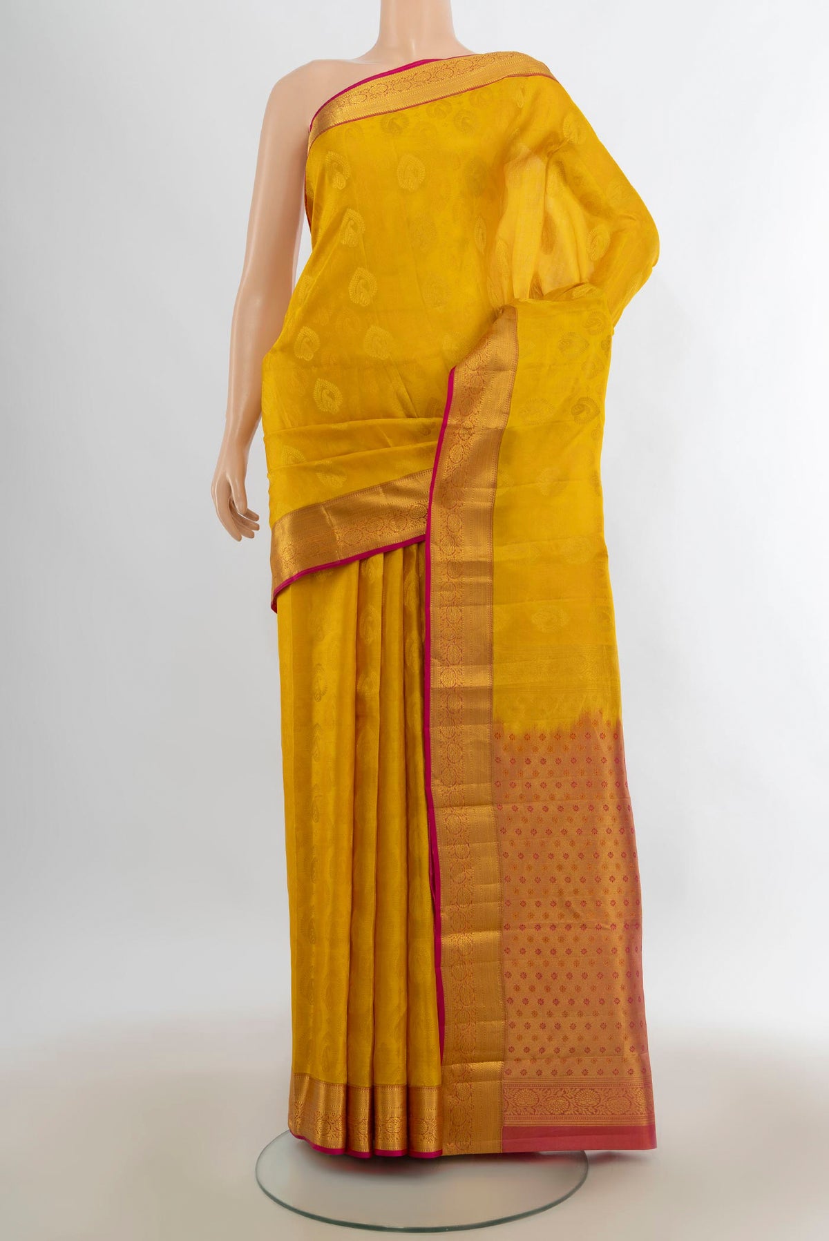 Pure Silk Mustard Kanchipuram Saree with Jacquard With Zari Butta on the body and Zari Border.  displayed on a mannequin