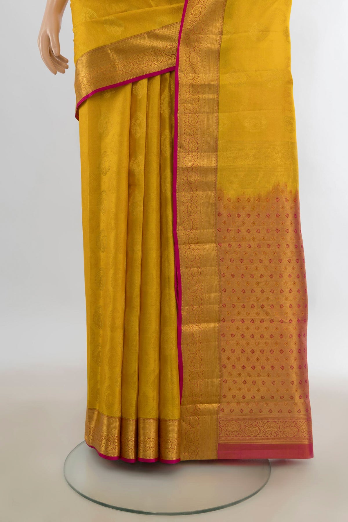 Pleats and pallu of Pure Silk Mustard Kanchipuram Saree with Jacquard With Zari Butta on the body and Zari Border. 