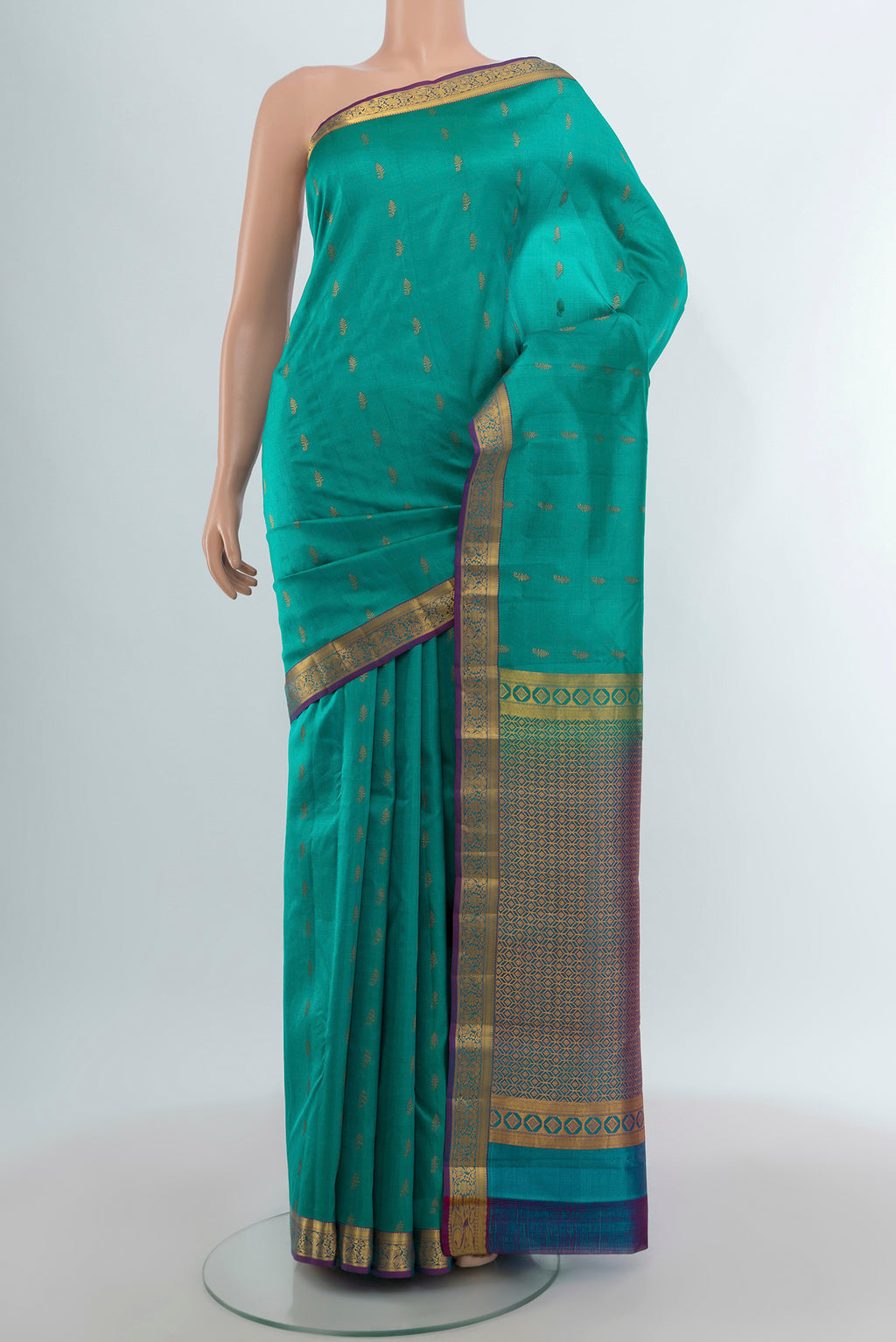 Turquoise Kanjivaram Silk Saree with Zari Butta on the body and Zari Border.  displayed on a mannequin