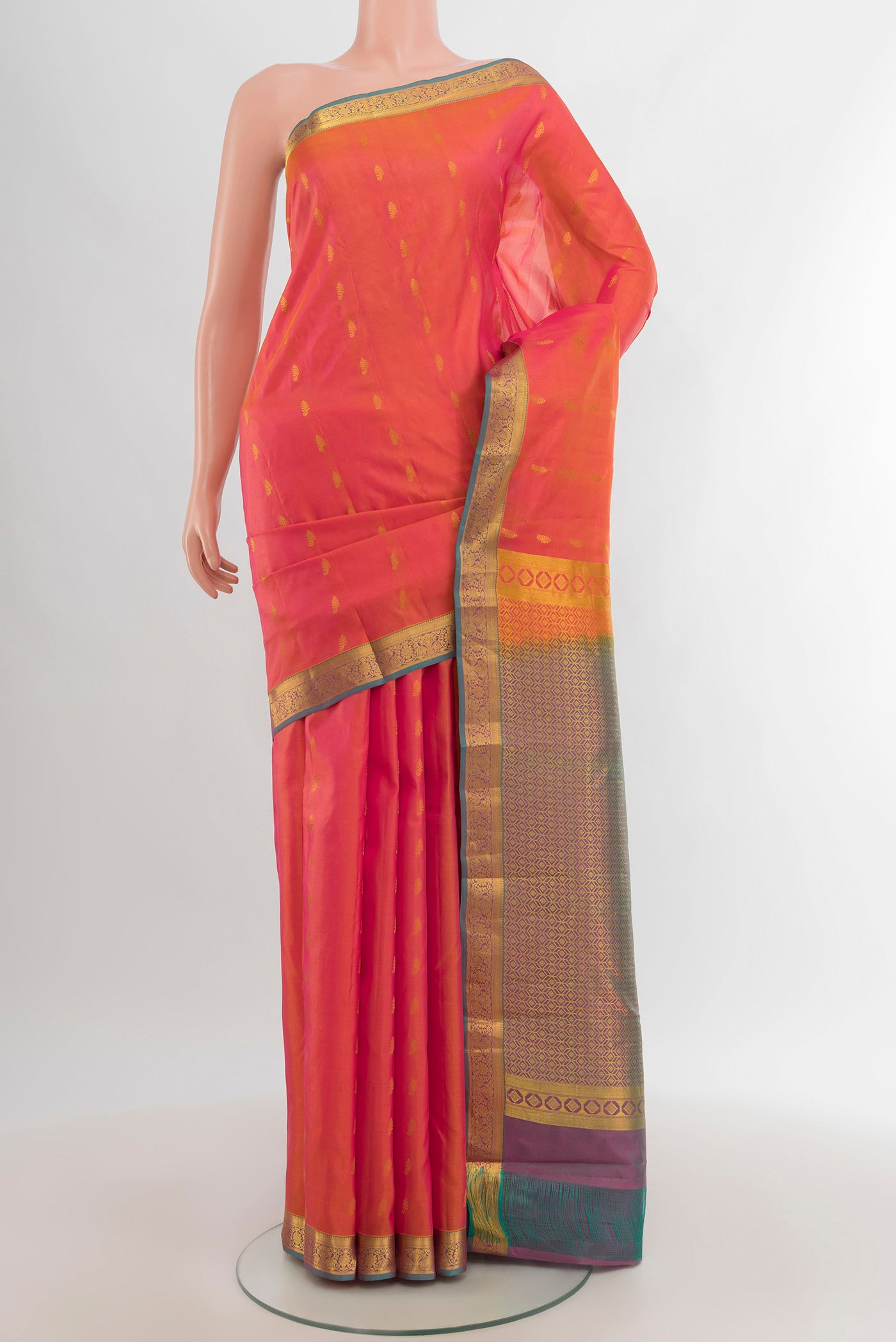 Golden Peach Kanjivaram Silk Saree with Zari Butta on the body and Zari Border.  displayed on a mannequin