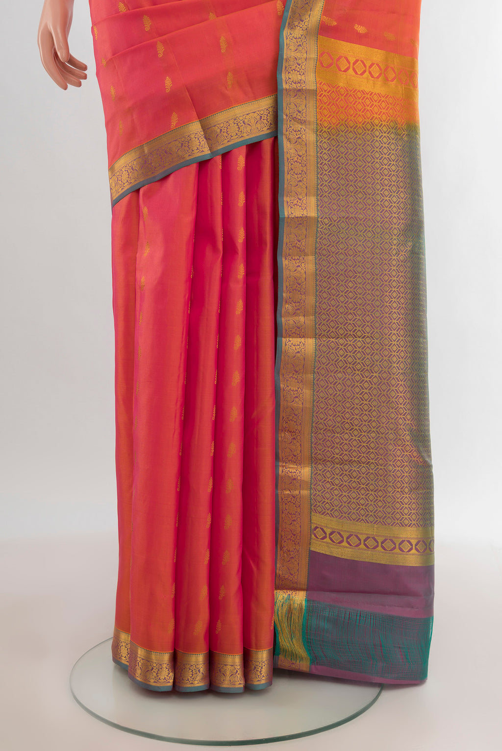 Pleats and pallu of Golden Peach Kanjivaram Silk Saree with Zari Butta on the body and Zari Border. 