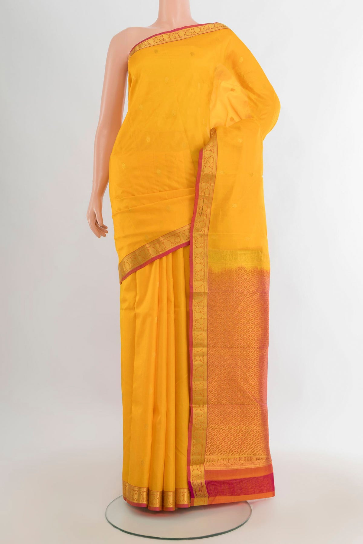 Pure Silk Yellow Kanjivaram Saree with Zari Butta on the body and Zari Border.  displayed on a mannequin