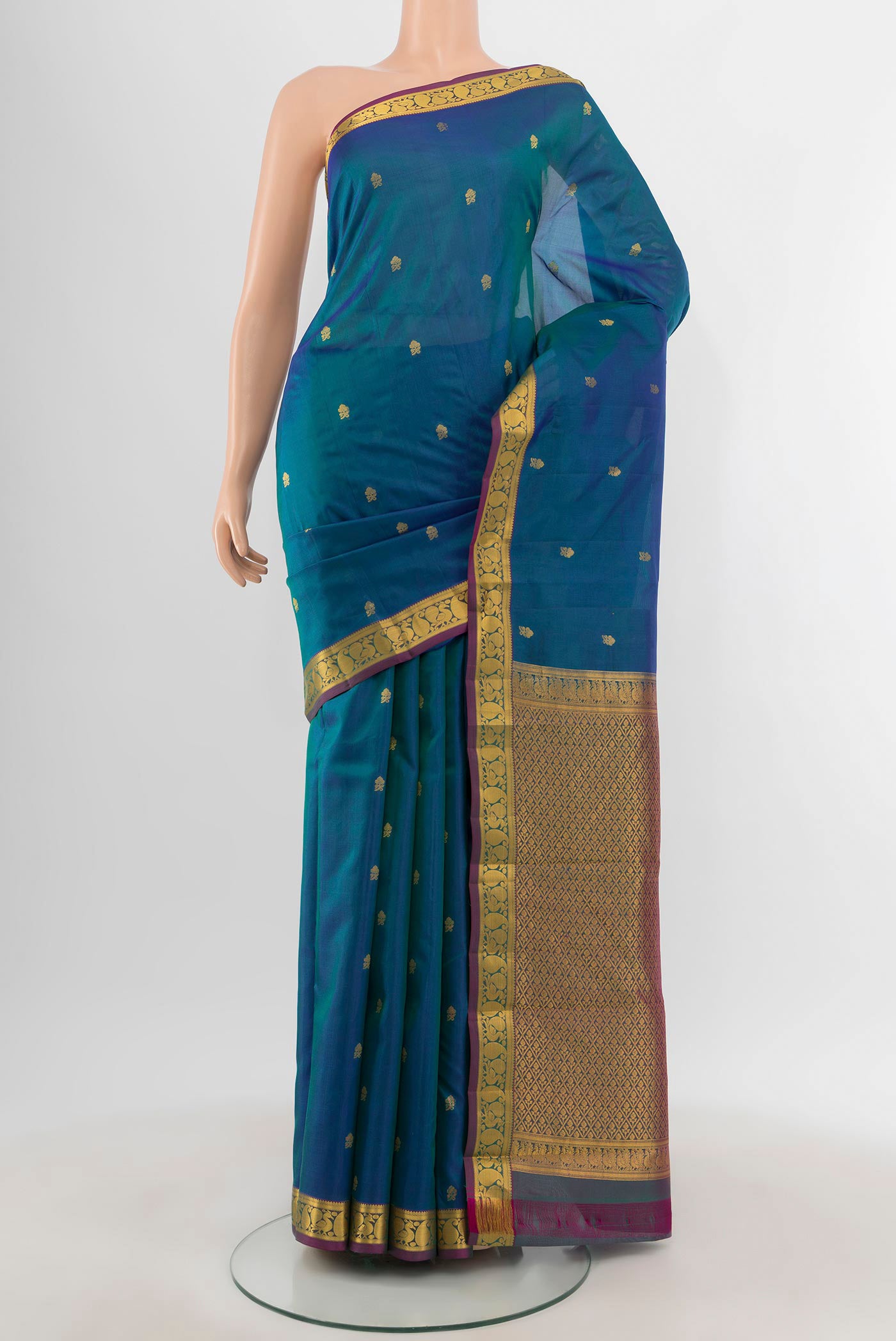 Peacock Blue Kanjivaram Silk Saree with Zari Butta on the body and Zari Border.  displayed on a mannequin