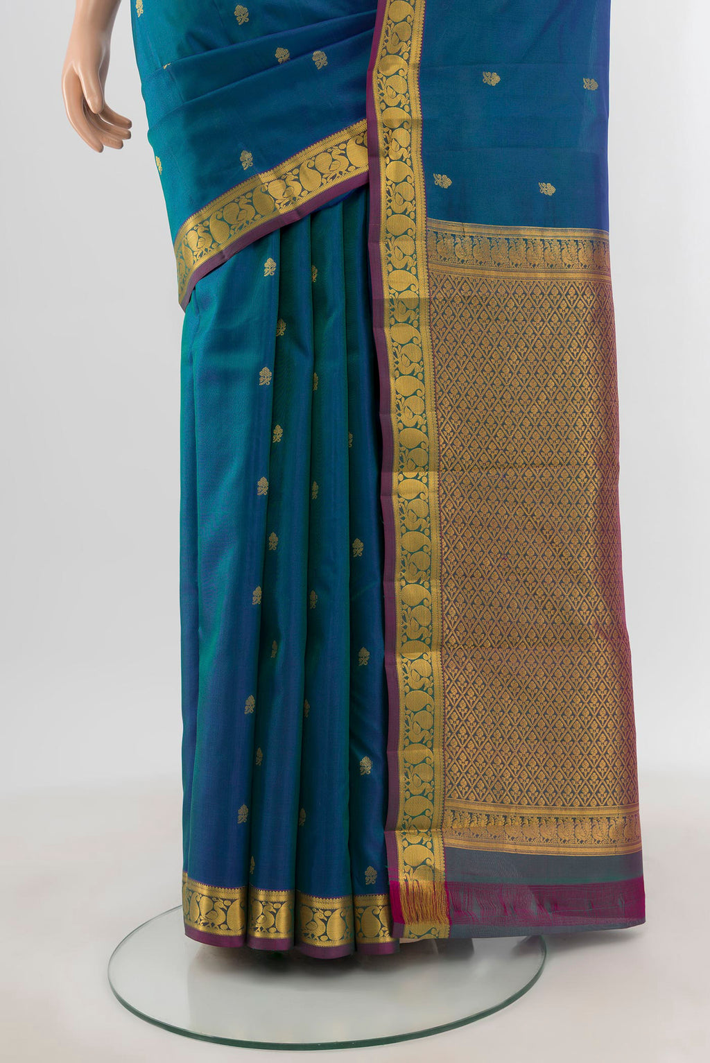 Pleats and pallu of Peacock Blue Kanjivaram Silk Saree with Zari Butta on the body and Zari Border. 