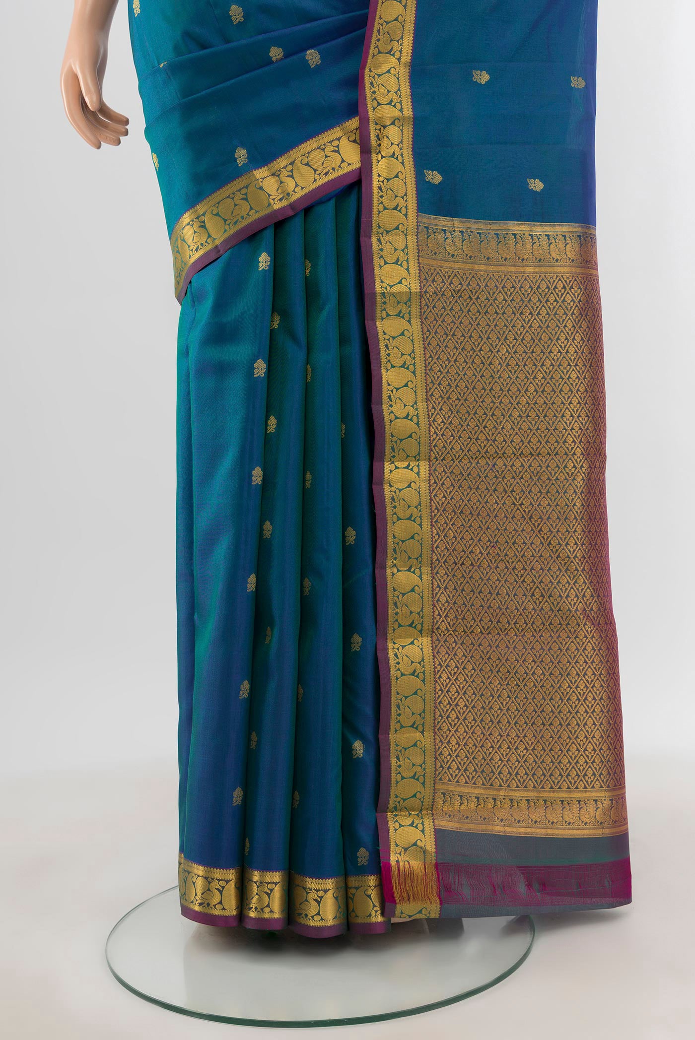 Pleats and pallu of Peacock Blue Kanjivaram Silk Saree with Zari Butta on the body and Zari Border. 