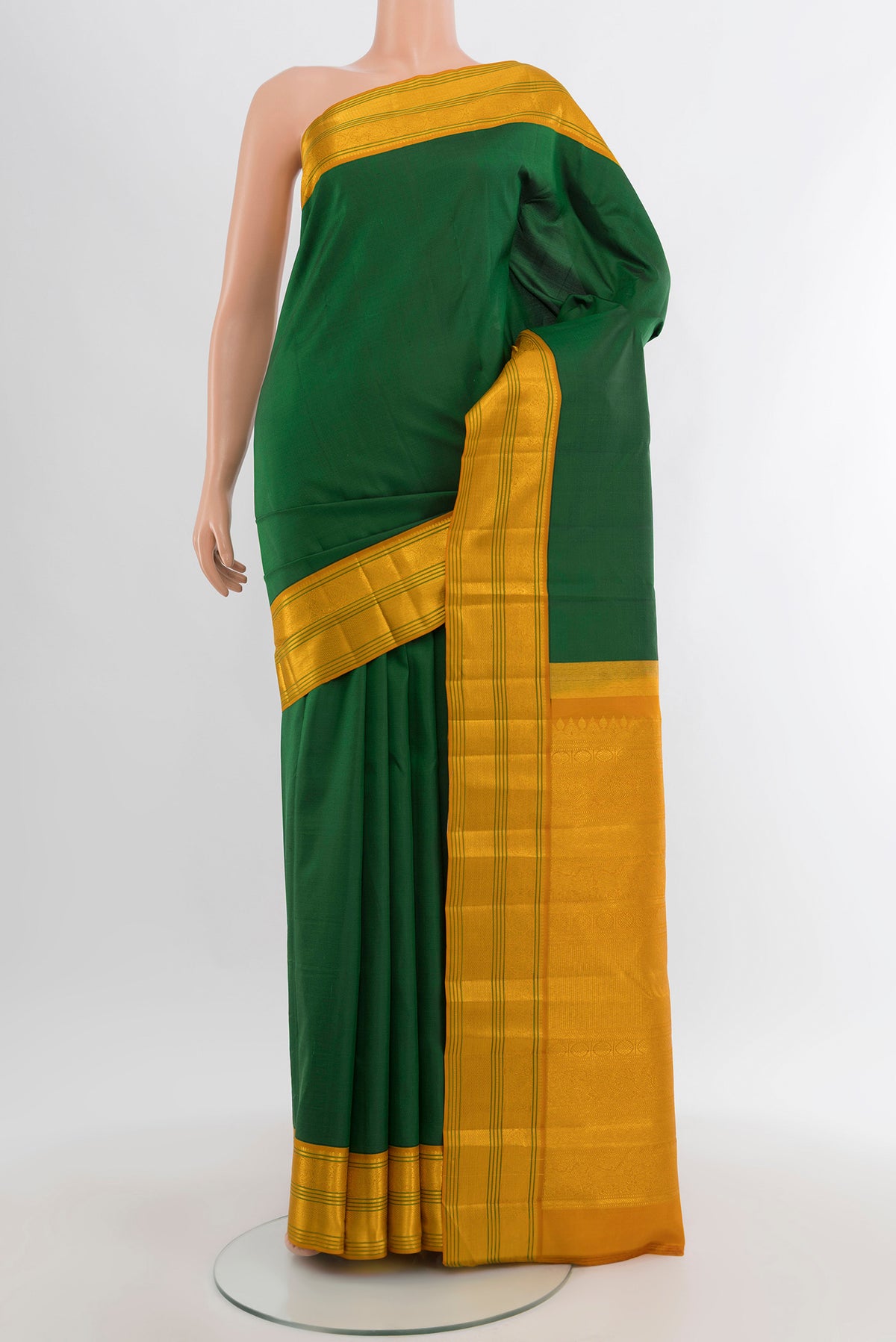 Bottle Green Kanchipuram Silk Saree with Plain Body and Zari Border.  displayed on a mannequin