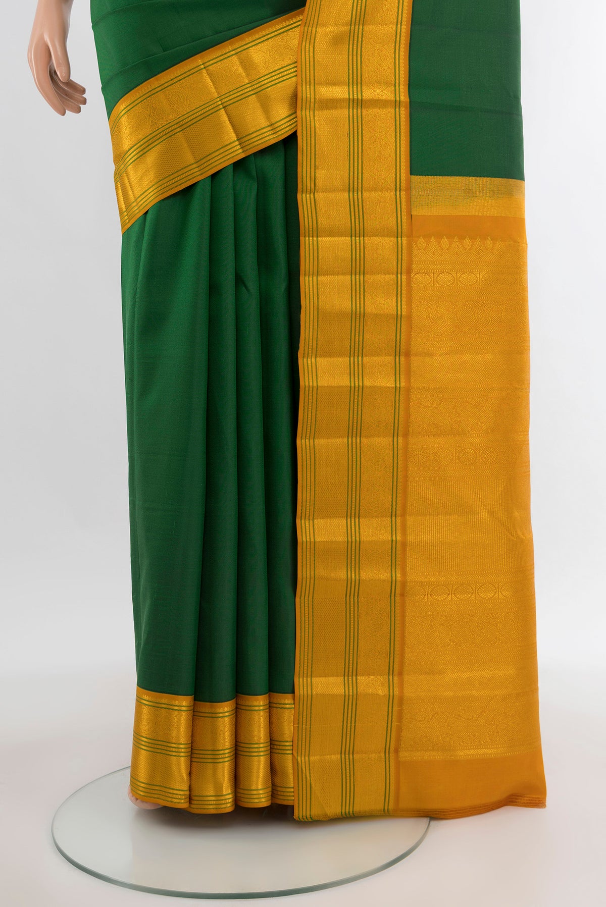 Pleats and pallu of Bottle Green Kanchipuram Silk Saree with Plain Body and Zari Border. 