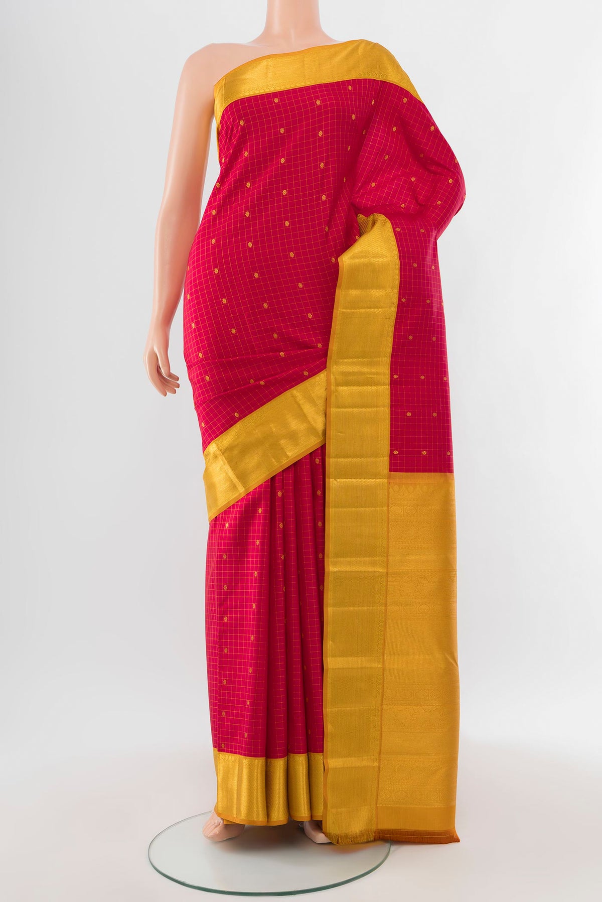 Maroon Kanjivaram Silk Saree with Zari Butta on the body and Silk Border.  displayed on a mannequin