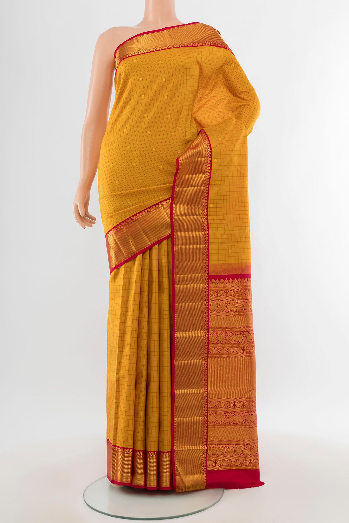Pure Silk Pure Zari Yellow Kanjivaram Saree with Zari Butta on the body and Silk Border.  displayed on a mannequin