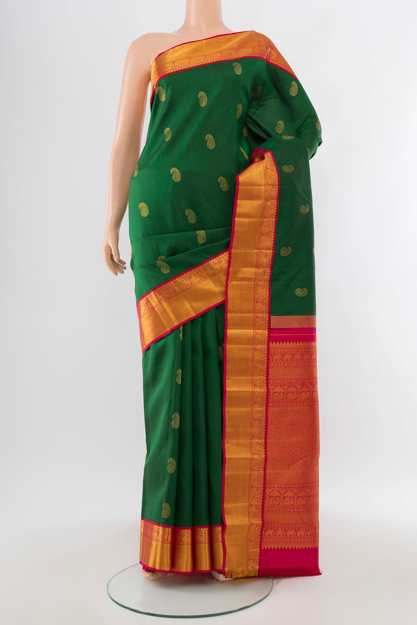 Mint Green Kanjivaram Silk Saree with Zari Butta on the body and Silk Border.  displayed on a mannequin