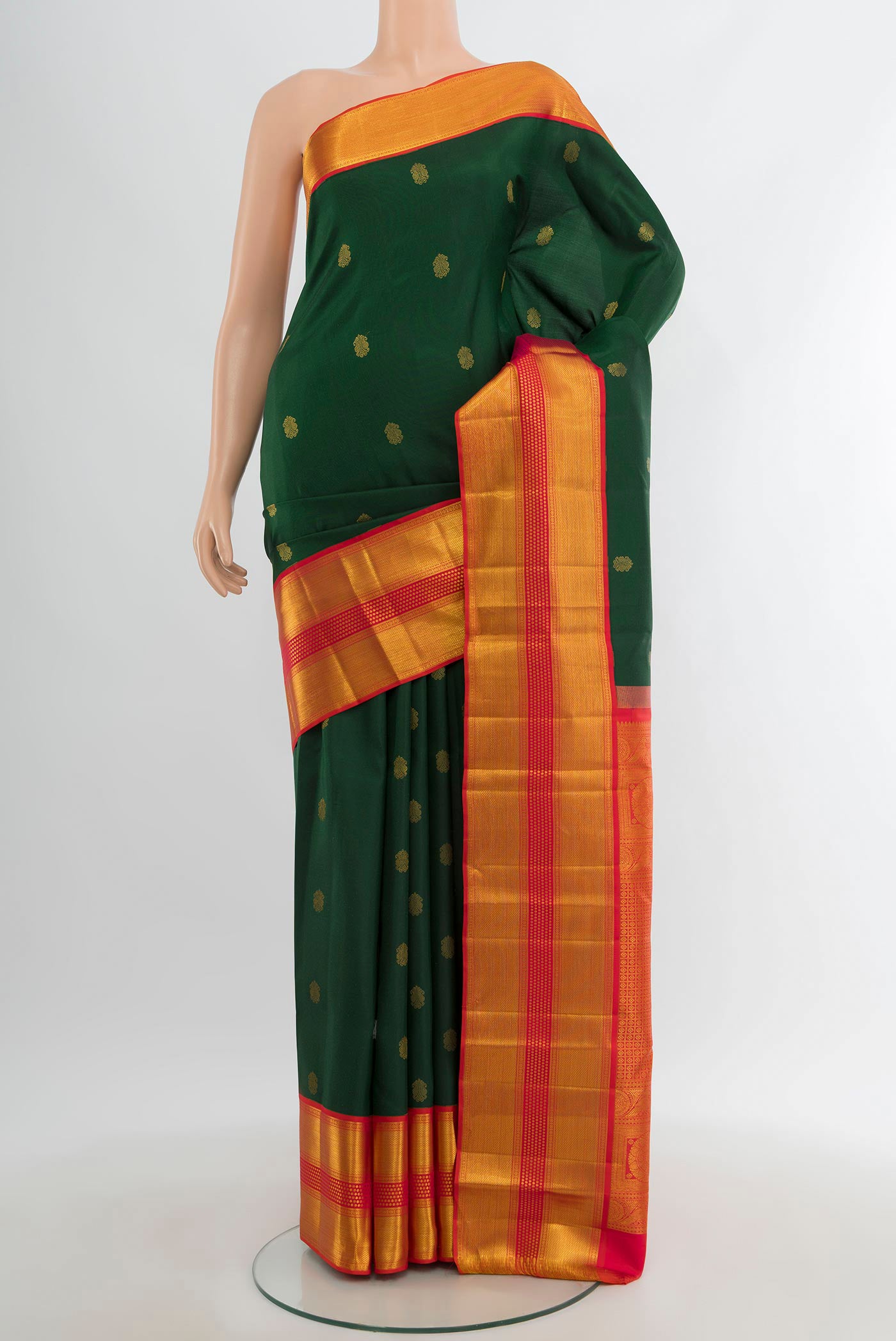 Bottle Green Kanjivaram Silk Saree with Zari Butta on the body and Zari Border.  displayed on a mannequin