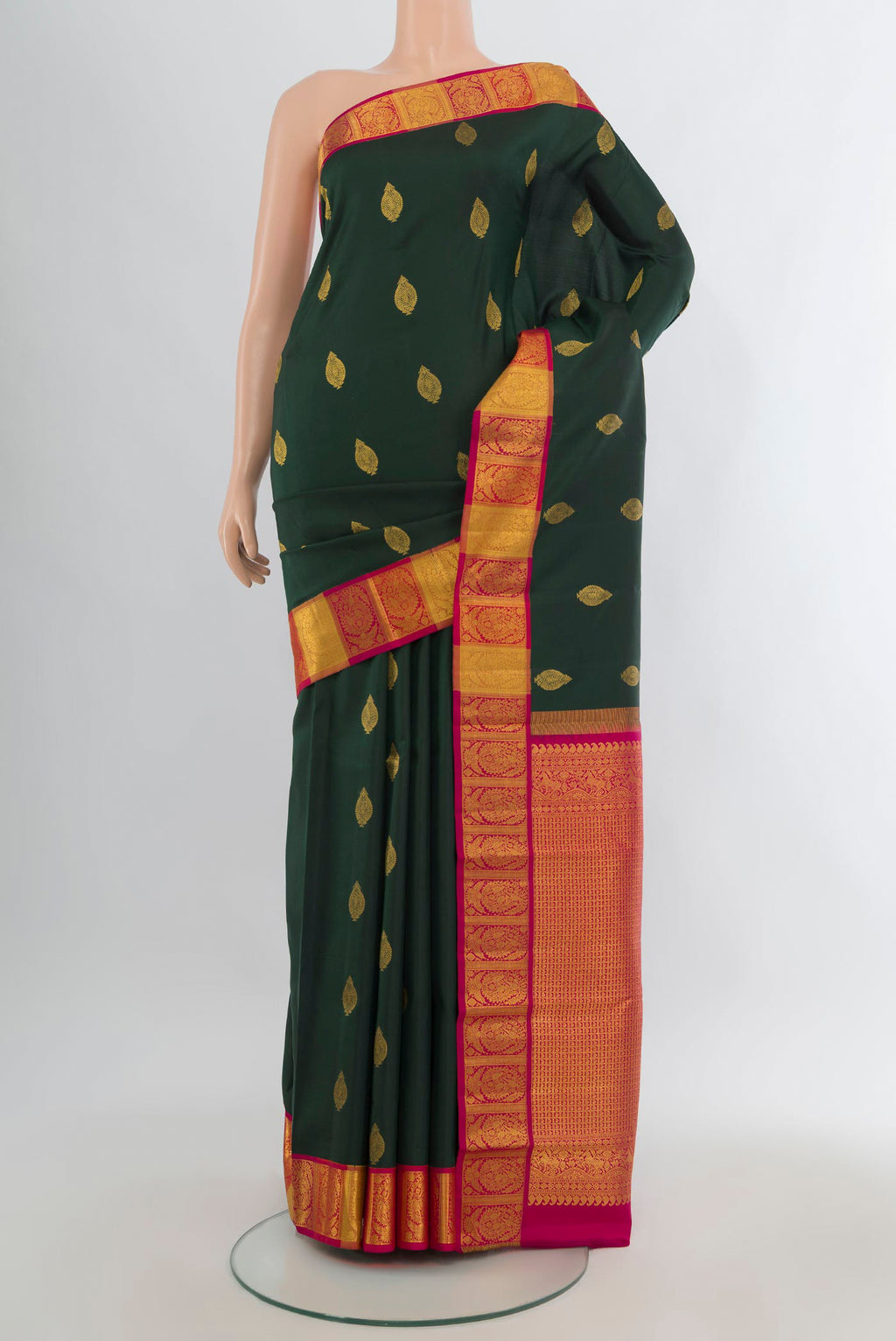 Pure Silk Bottle Green Kanchipuram Saree with Zari Butta on the body and Zari Border.  displayed on a mannequin