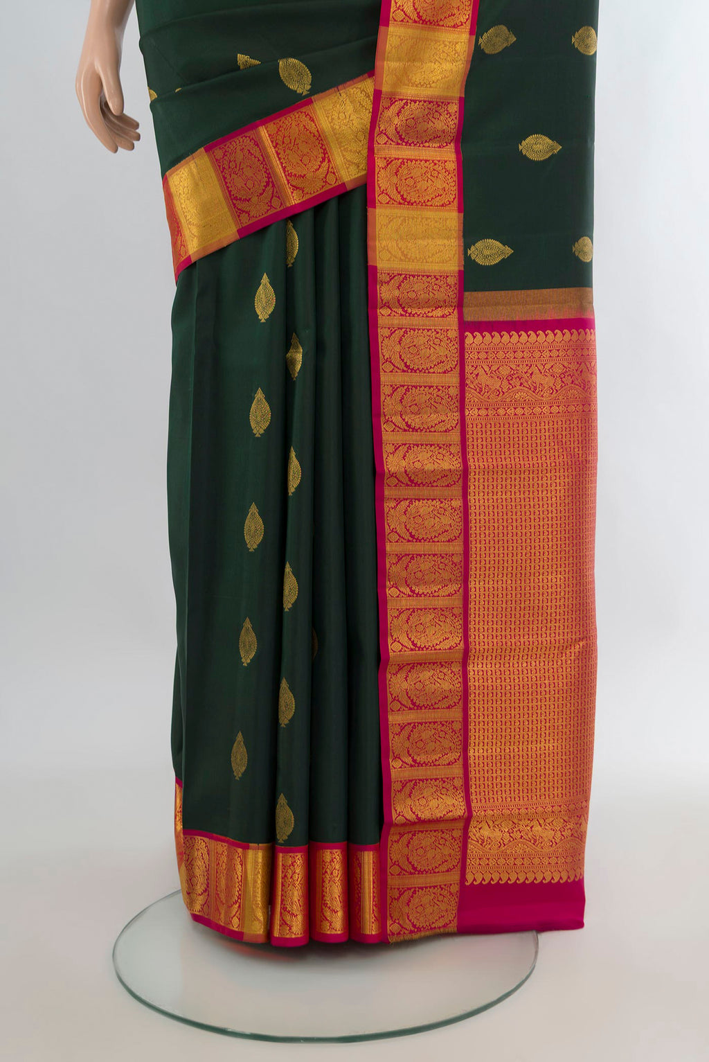 Pleats and pallu of Pure Silk Bottle Green Kanchipuram Saree with Zari Butta on the body and Zari Border. 