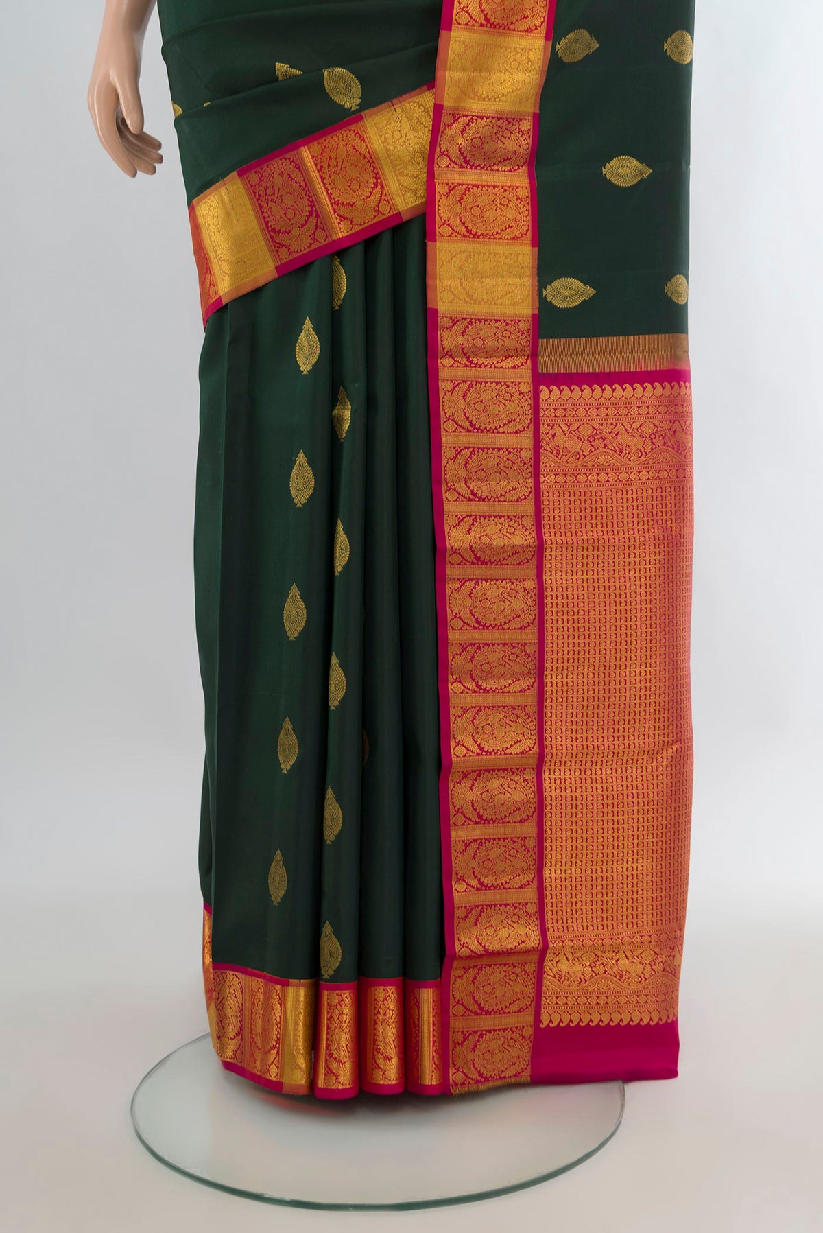 Pleats and pallu of Pure Silk Bottle Green Kanchipuram Saree with Zari Butta on the body and Zari Border. 