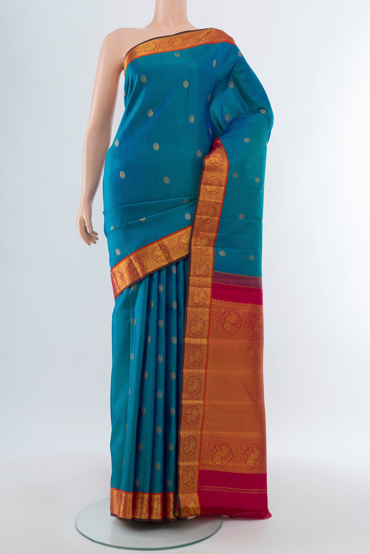 Pure Silk Pure Zari Dark Blue Kanchipuram Saree with Zari Butta on the body and Silk Border.  displayed on a mannequin