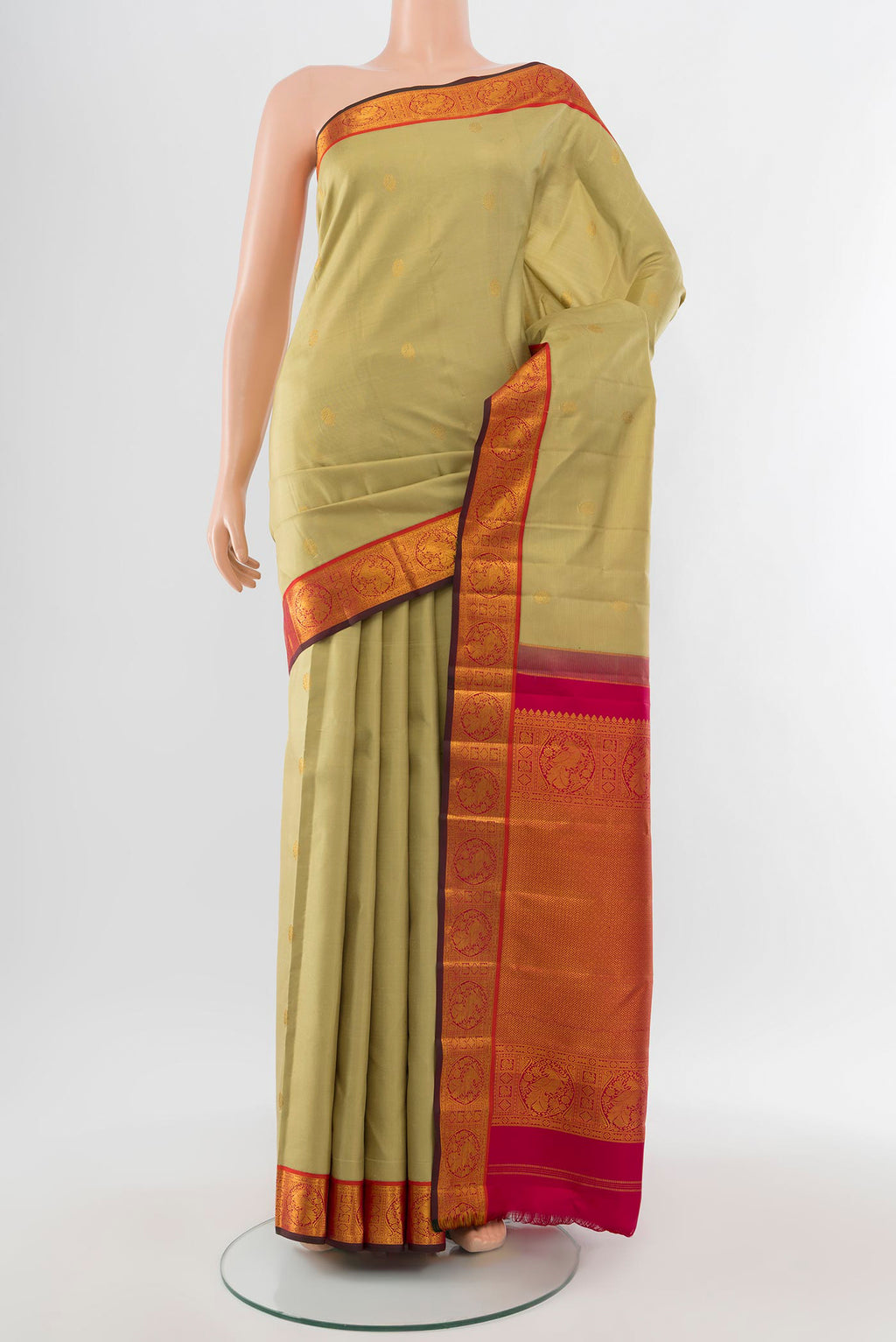 Pure Silk Pure Zari Sandal Kanchipuram Saree with Zari Butta on the body and Silk Border.  displayed on a mannequin