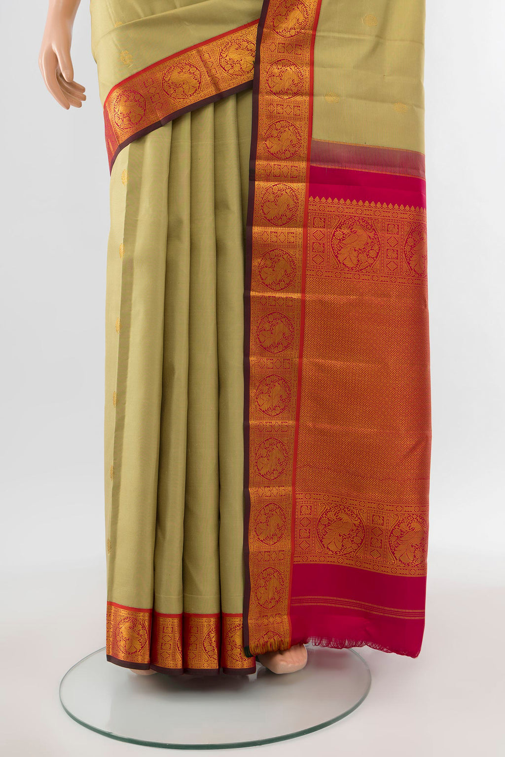 Pleats and pallu of Pure Silk Pure Zari Sandal Kanchipuram Saree with Zari Butta on the body and Silk Border. 
