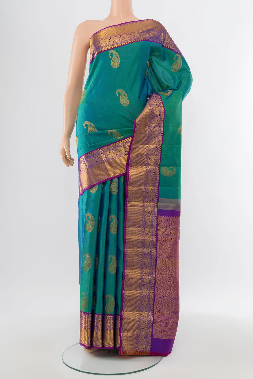 Pure Silk Pure Zari Peacock Blue Kanchipuram Saree with Zari Butta on the body and Silk Border.  displayed on a mannequin