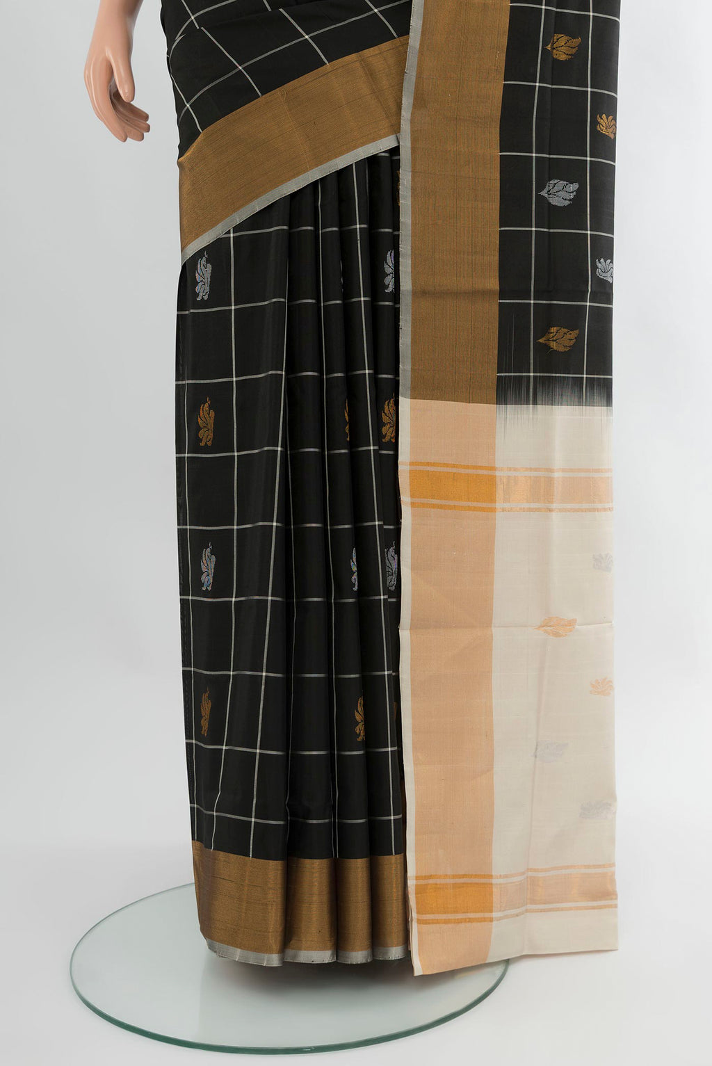 Pleats and pallu of Black Uppada Silk Saree with Checked design on the body and Zari Border. 