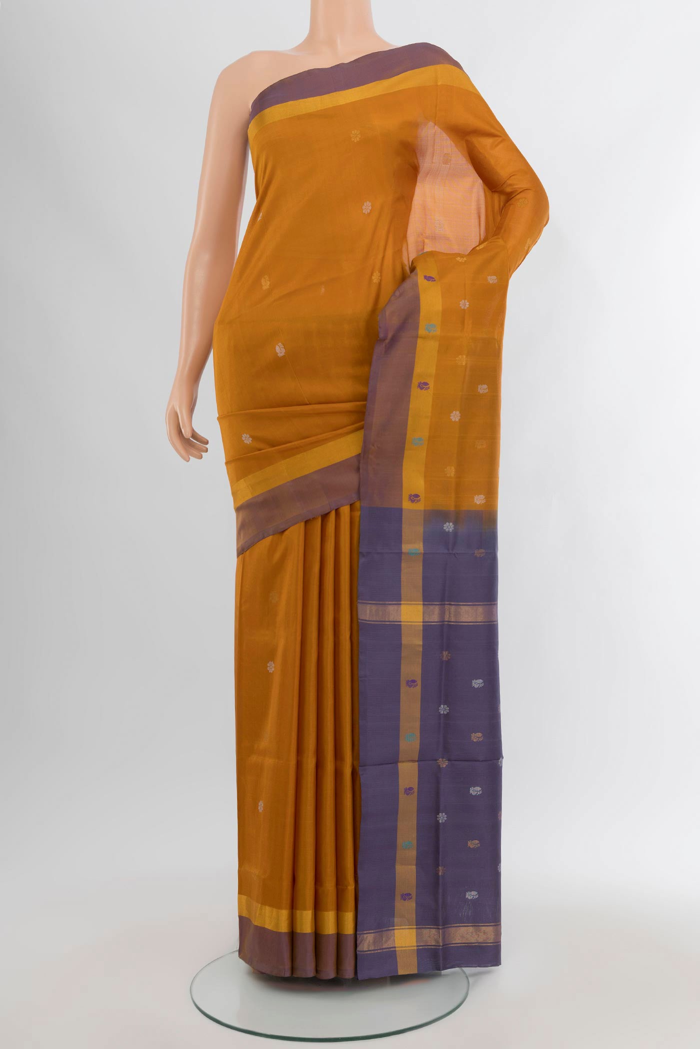 Mustard Uppada Silk Saree with Zari Butta on the body and Plain Border.  displayed on a mannequin