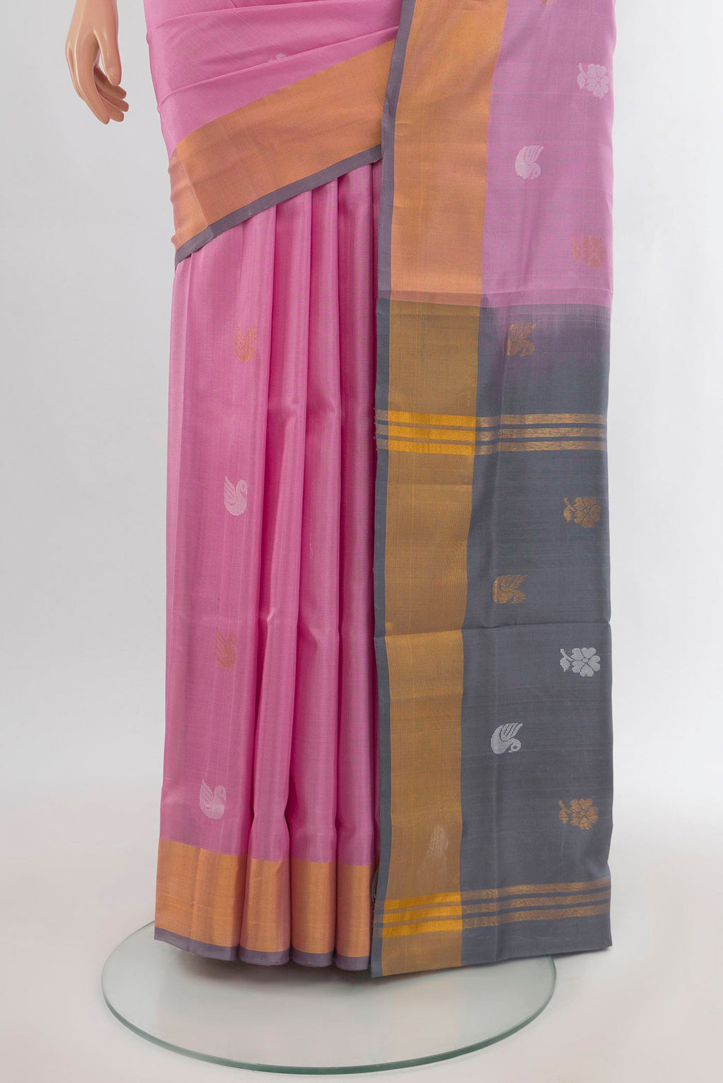 Pleats and pallu of Rose pink Uppada Silk Saree with Zari Butta on the body and Zari Border. 