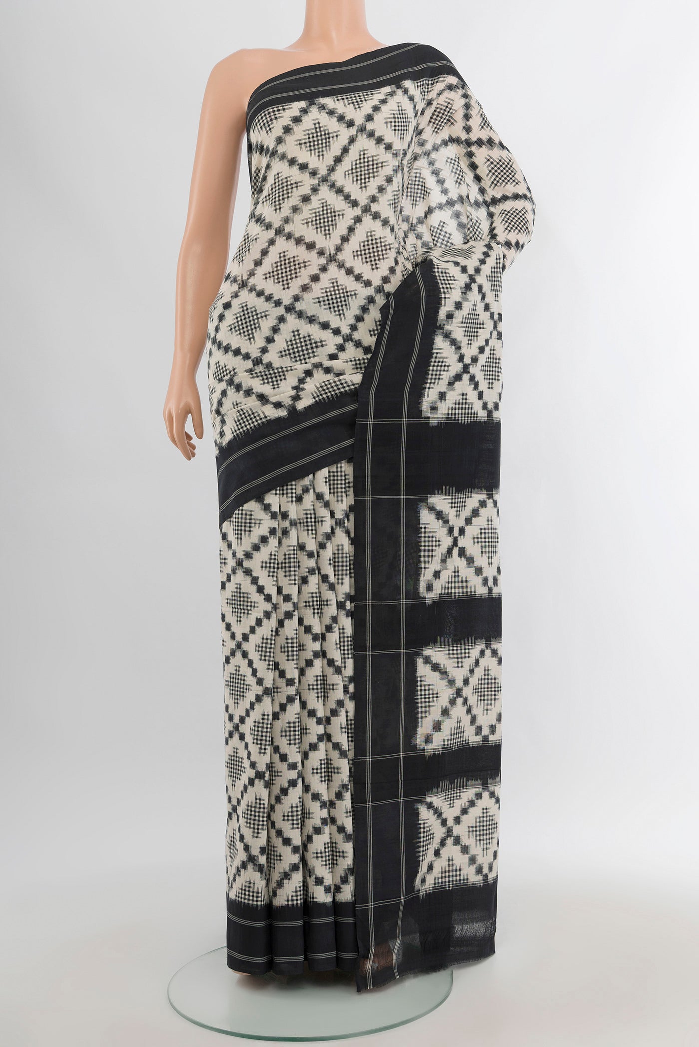 Off White Pochampally Cotton Saree with Ikat design on the body and Plain Border.  displayed on a mannequin