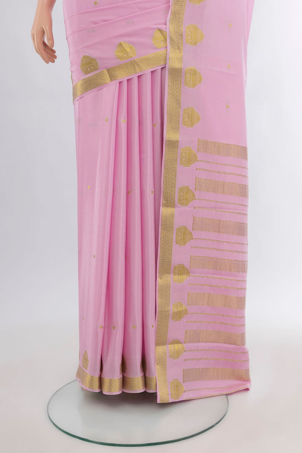 Pleats and pallu of Rose pink Mysore Crepe Saree with Zari Butta on the body and Zari Border. 