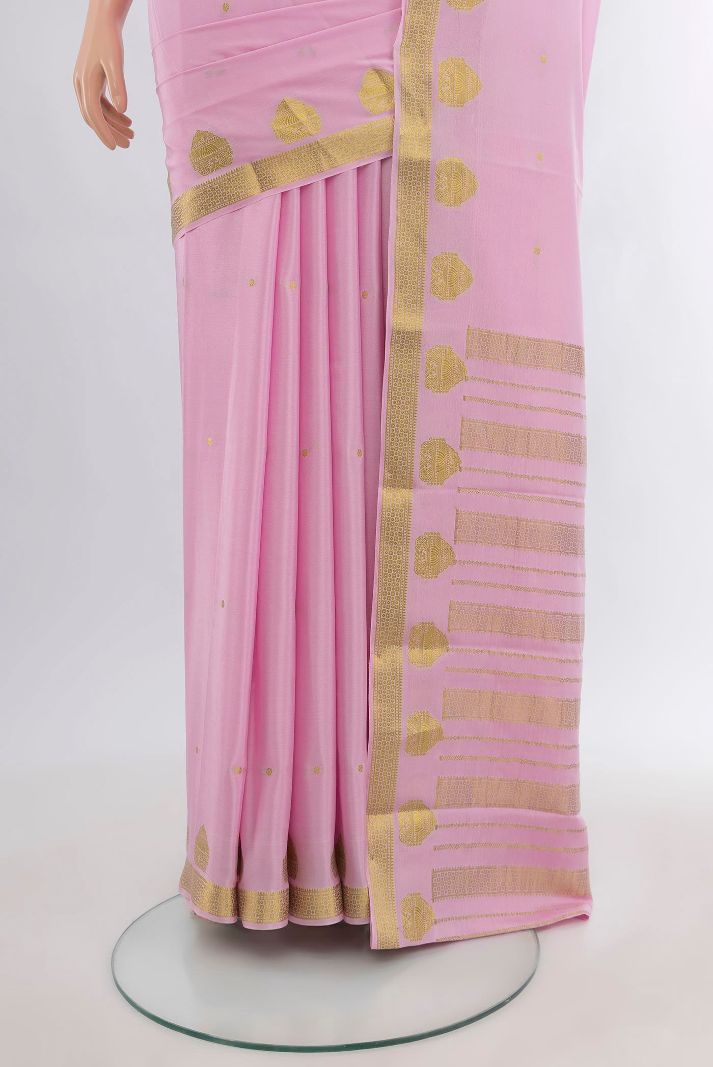 Pleats and pallu of Rose pink Mysore Crepe Saree with Zari Butta on the body and Zari Border. 
