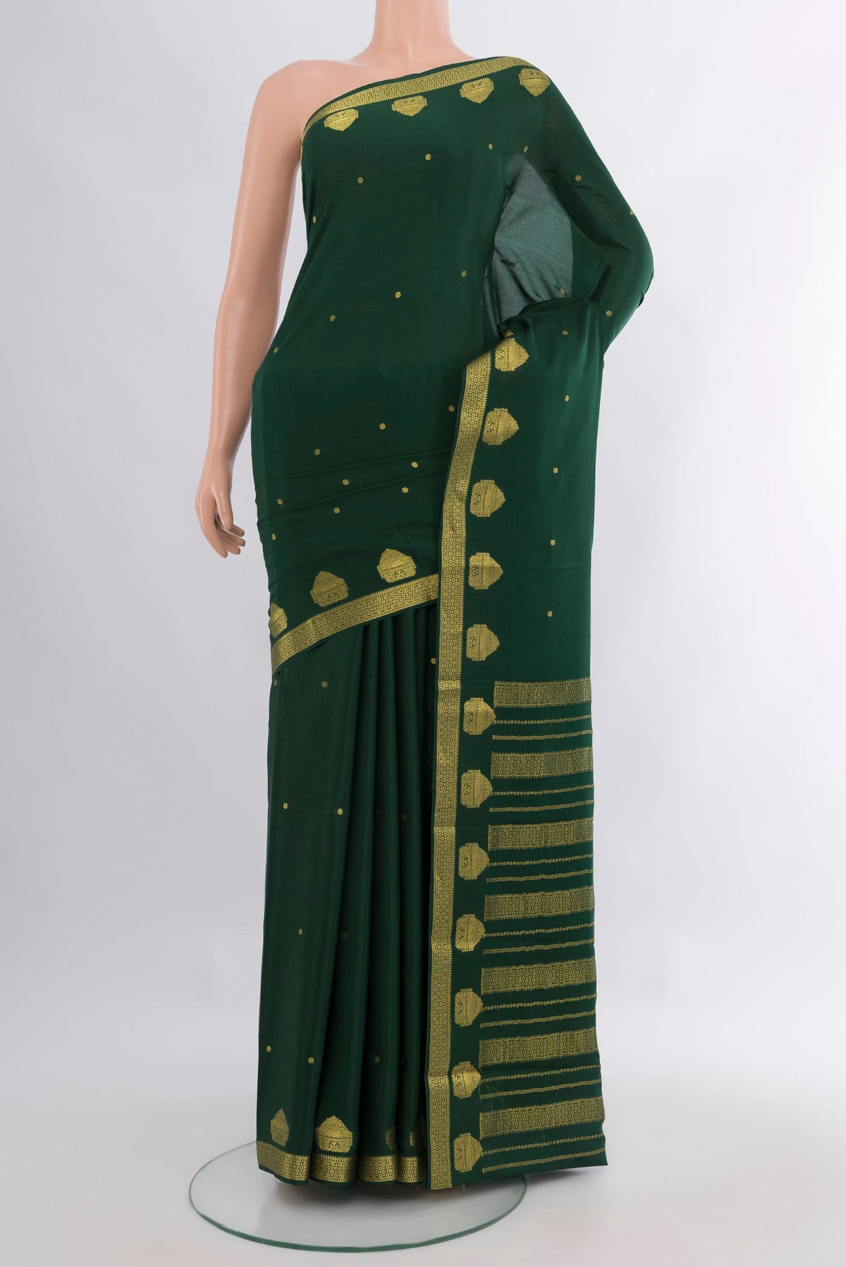 Bottle Green Mysore Crepe Saree with Zari Butta on the body and Zari Border.  displayed on a mannequin