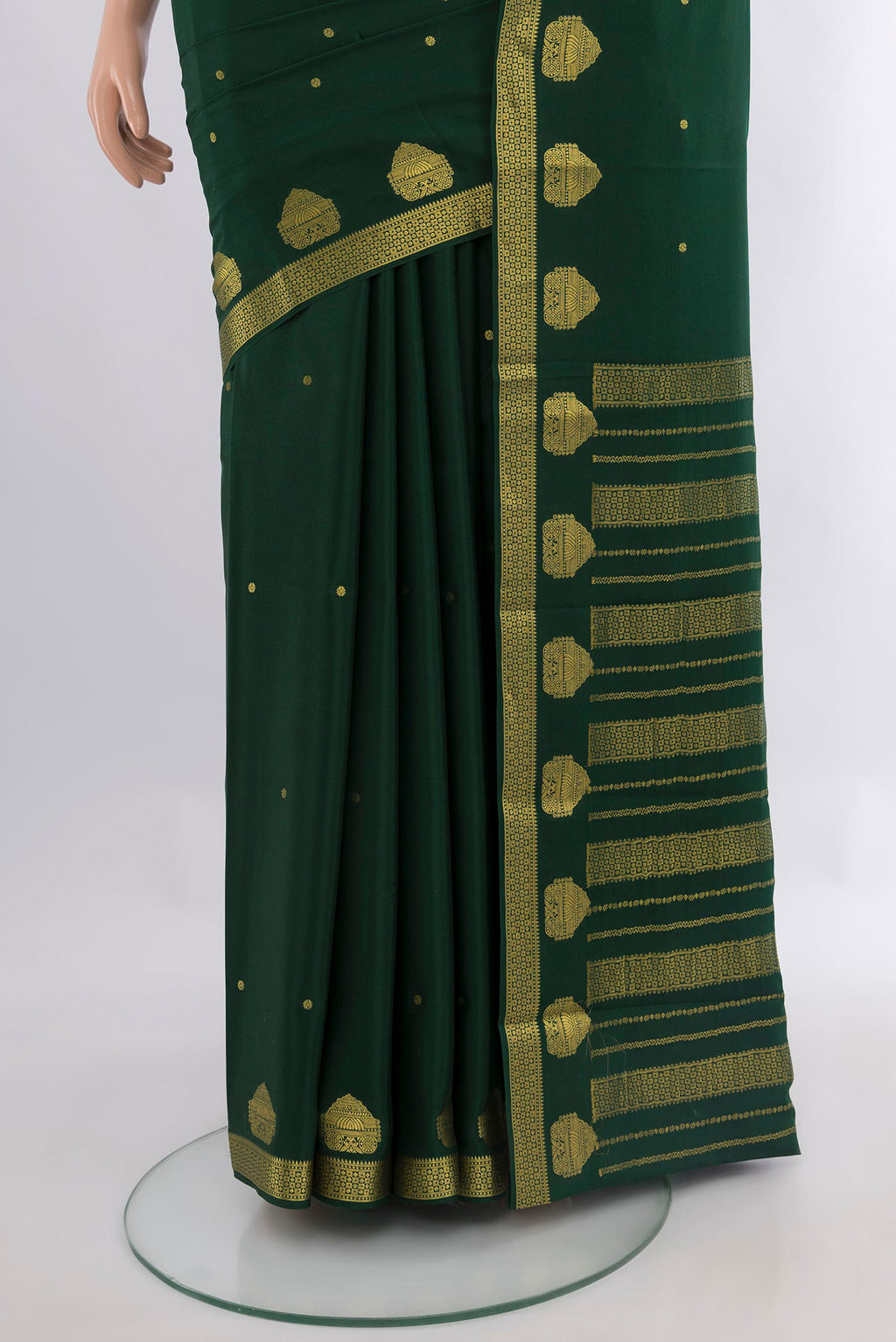 Pleats and pallu of Bottle Green Mysore Crepe Saree with Zari Butta on the body and Zari Border. 