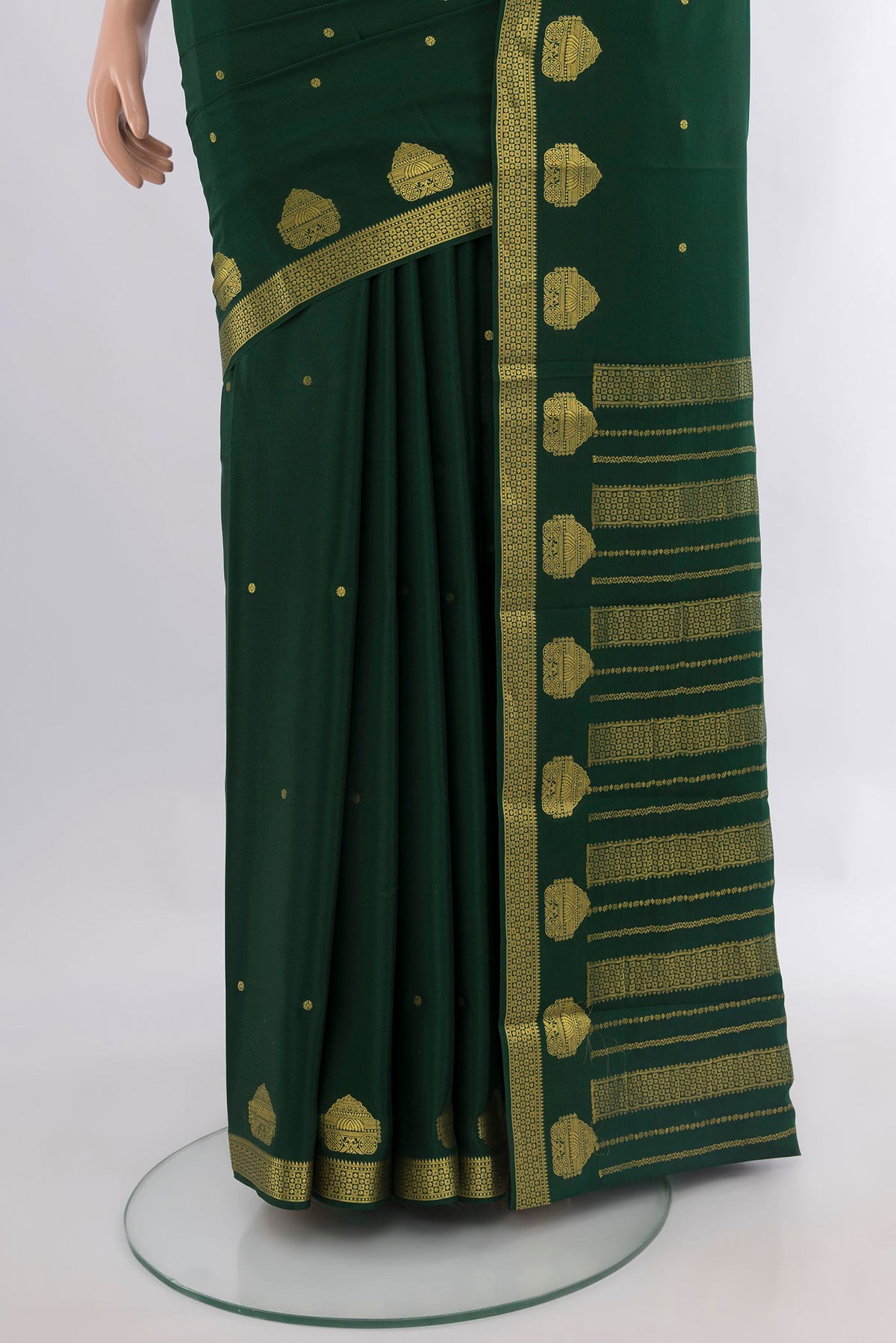 Pleats and pallu of Bottle Green Mysore Crepe Saree with Zari Butta on the body and Zari Border. 