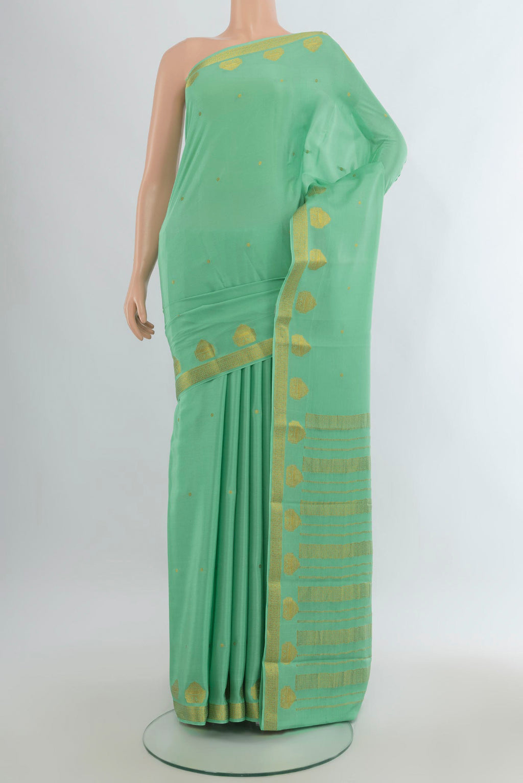 Pista Green Mysore Crepe Saree with Zari Butta on the body and Zari Border.  displayed on a mannequin