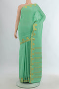 Pista Green Mysore Crepe Saree with Zari Butta on the body and Zari Border.  displayed on a mannequin