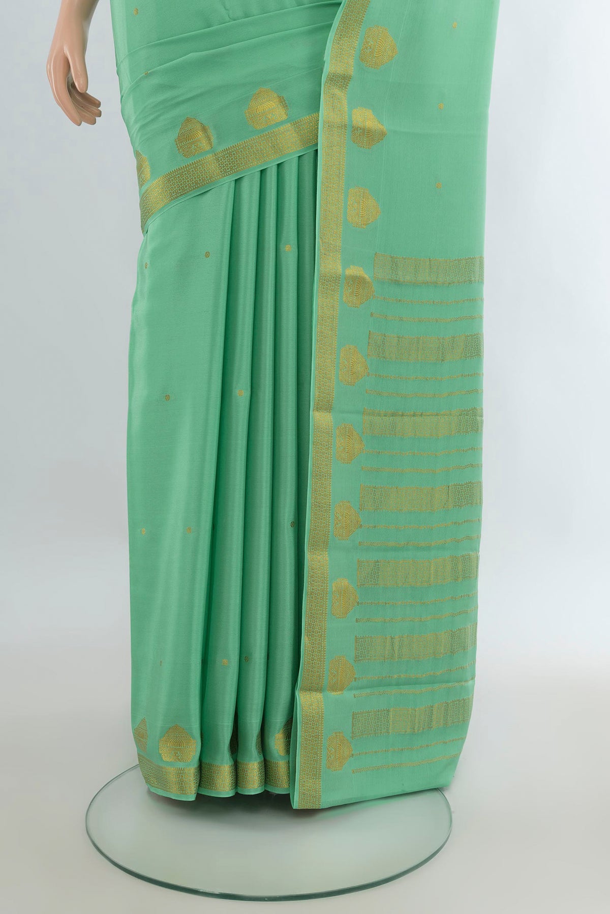Pleats and pallu of Pista Green Mysore Crepe Saree with Zari Butta on the body and Zari Border. 