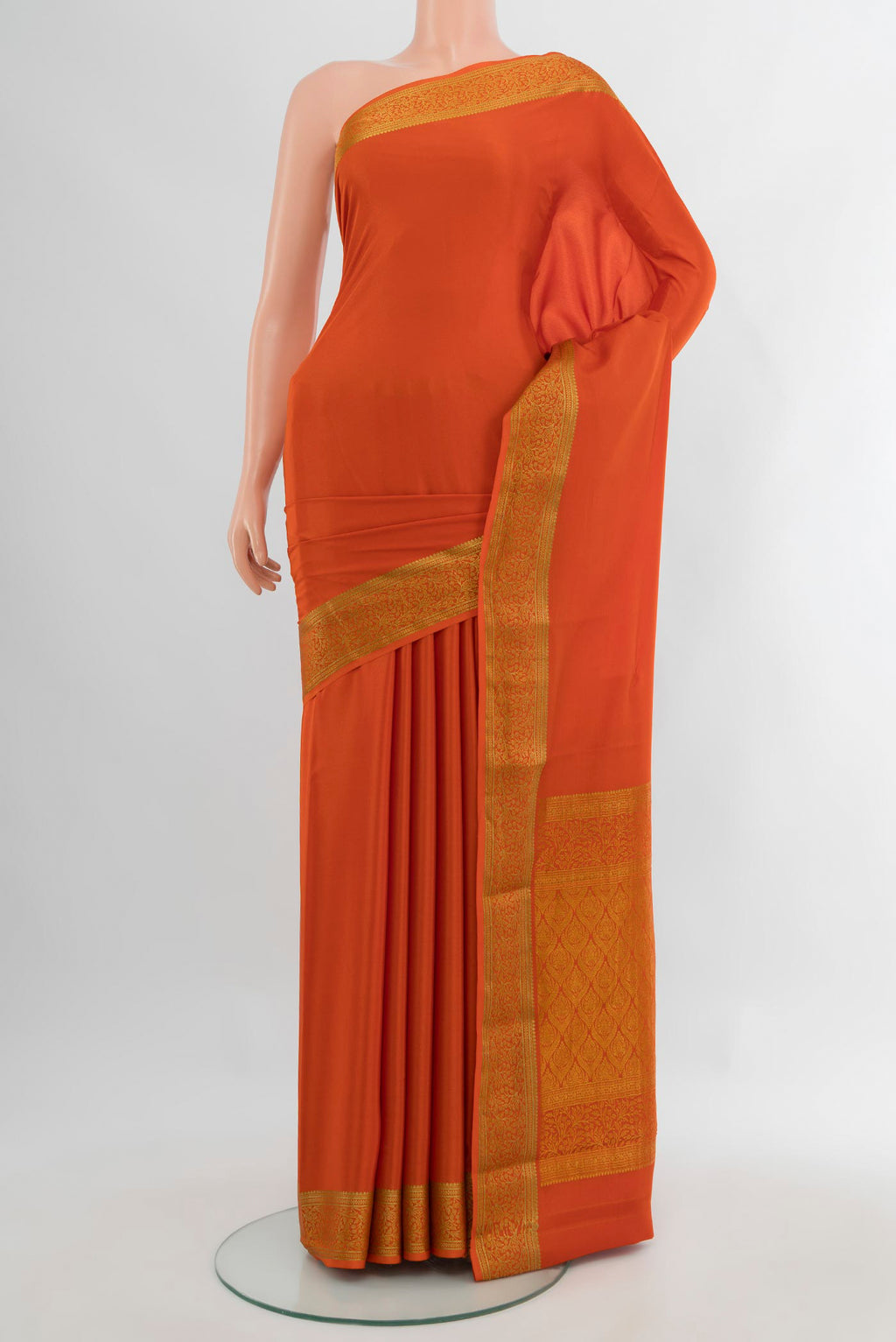 Rust Mysore Crepe Saree with Plain Body and Zari Border.  displayed on a mannequin