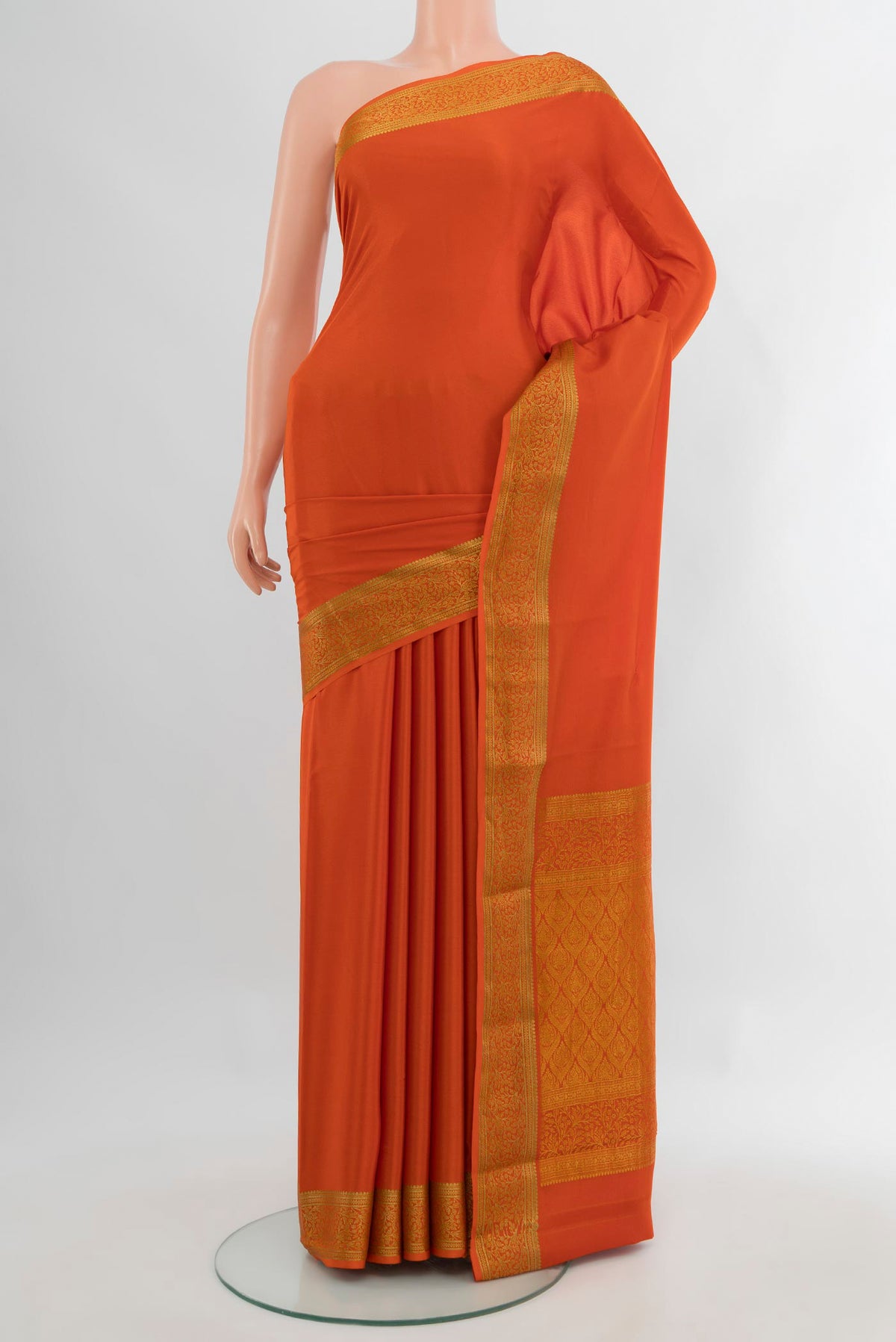 Rust Mysore Crepe Saree with Plain Body and Zari Border.  displayed on a mannequin