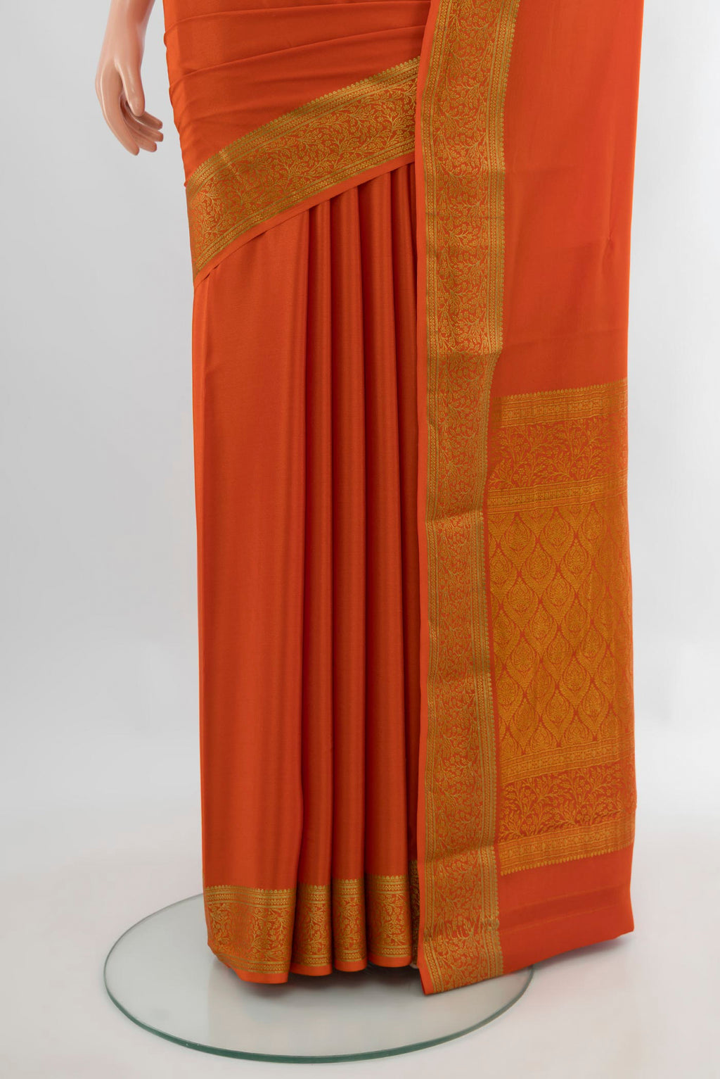 Pleats and pallu of Rust Mysore Crepe Saree with Plain Body and Zari Border. 