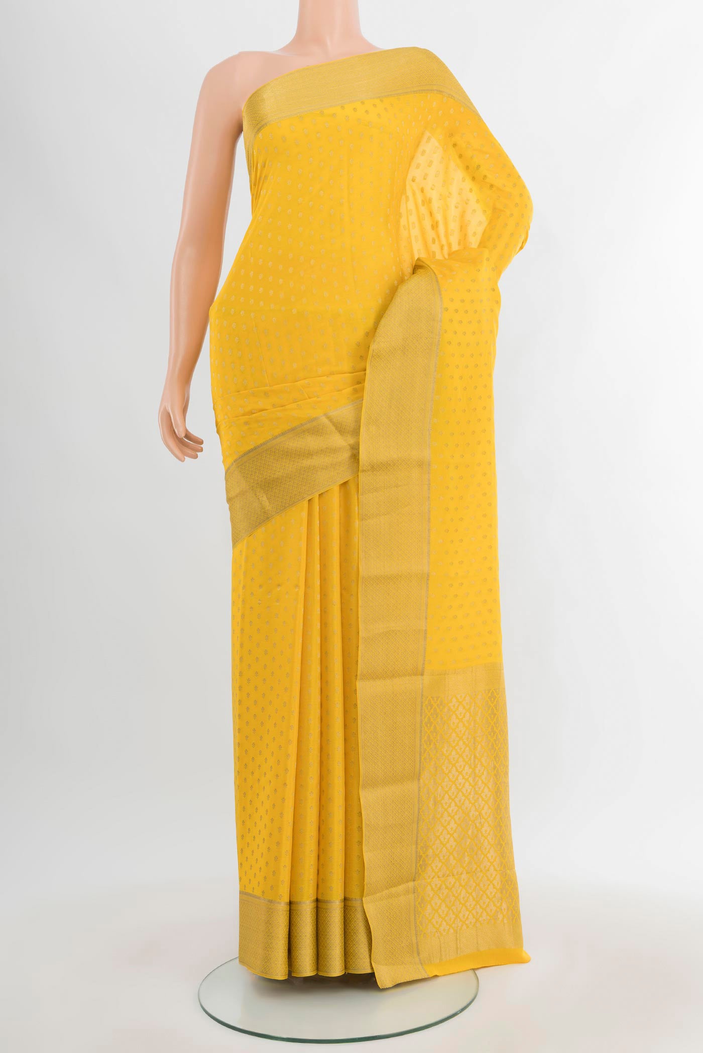 Yellow Mysore Crepe Saree with Zari Butta on the body and Zari Border.  displayed on a mannequin