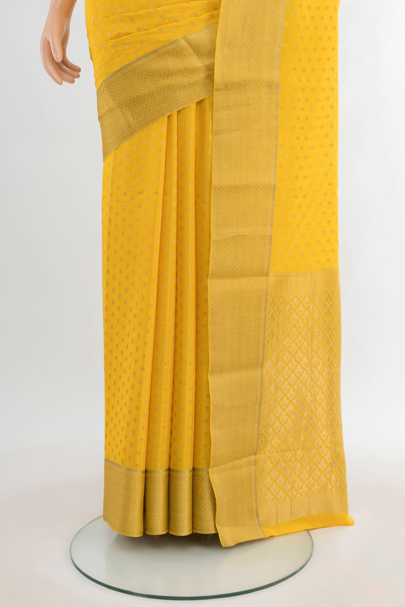 Pleats and pallu of Yellow Mysore Crepe Saree with Zari Butta on the body and Zari Border. 