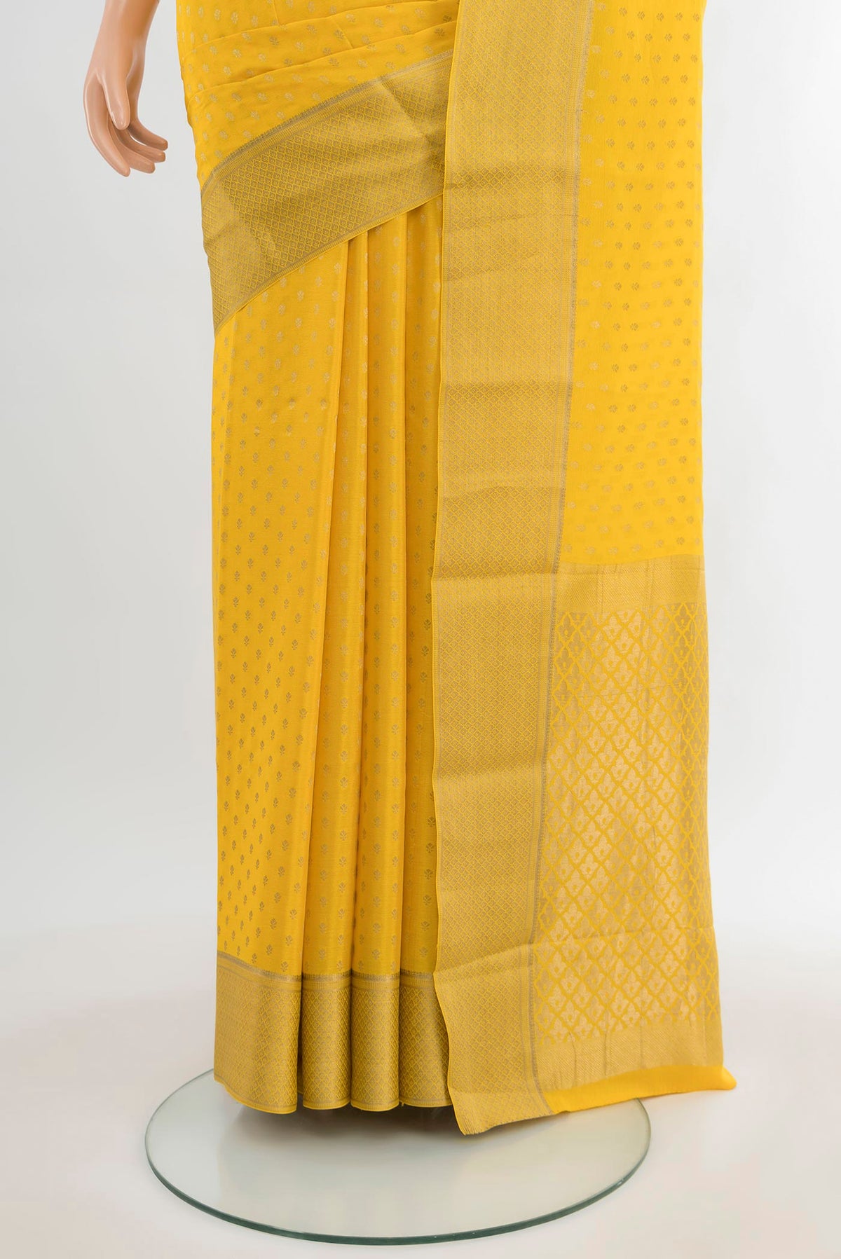 Pleats and pallu of Yellow Mysore Crepe Saree with Zari Butta on the body and Zari Border. 