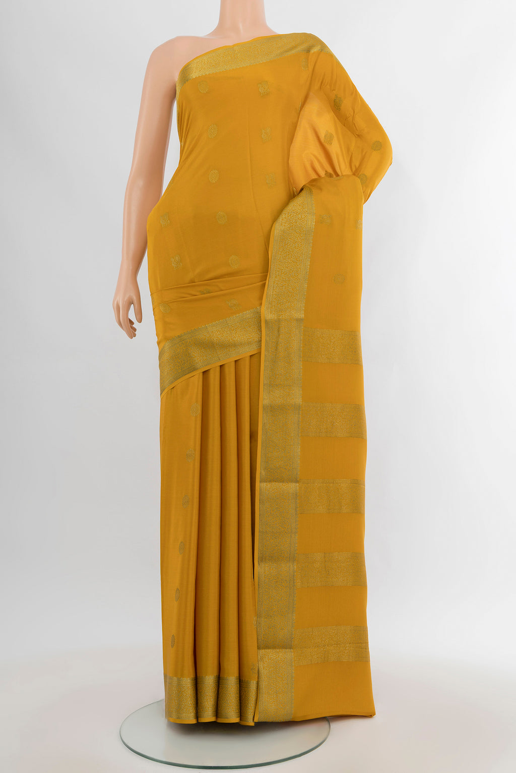 Mustard Mysore Crepe Saree with Zari Butta on the body and Zari Border.  displayed on a mannequin