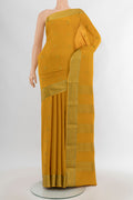 Mustard Mysore Crepe Saree with Zari Butta on the body and Zari Border.  displayed on a mannequin