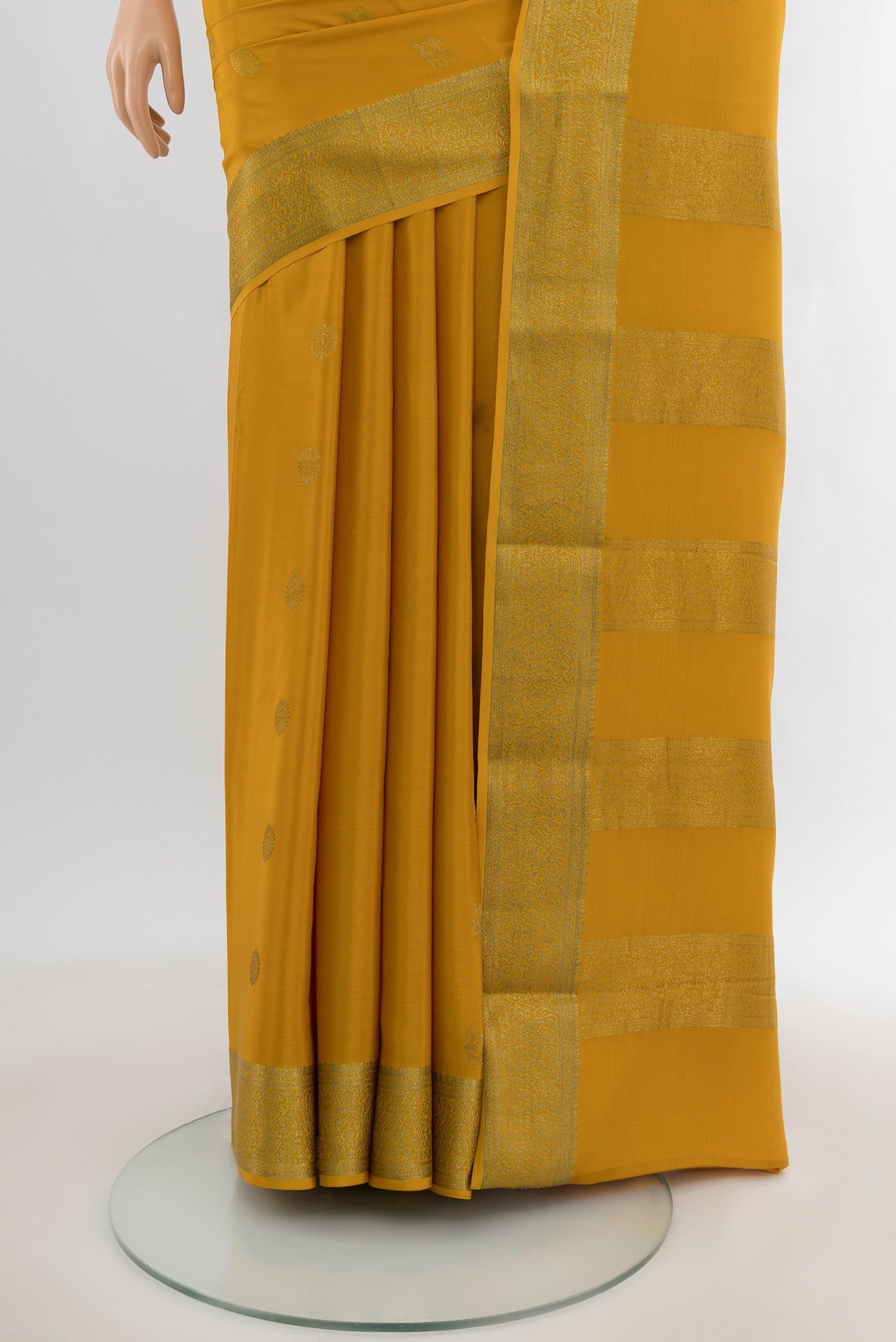 Pleats and pallu of Mustard Mysore Crepe Saree with Zari Butta on the body and Zari Border. 