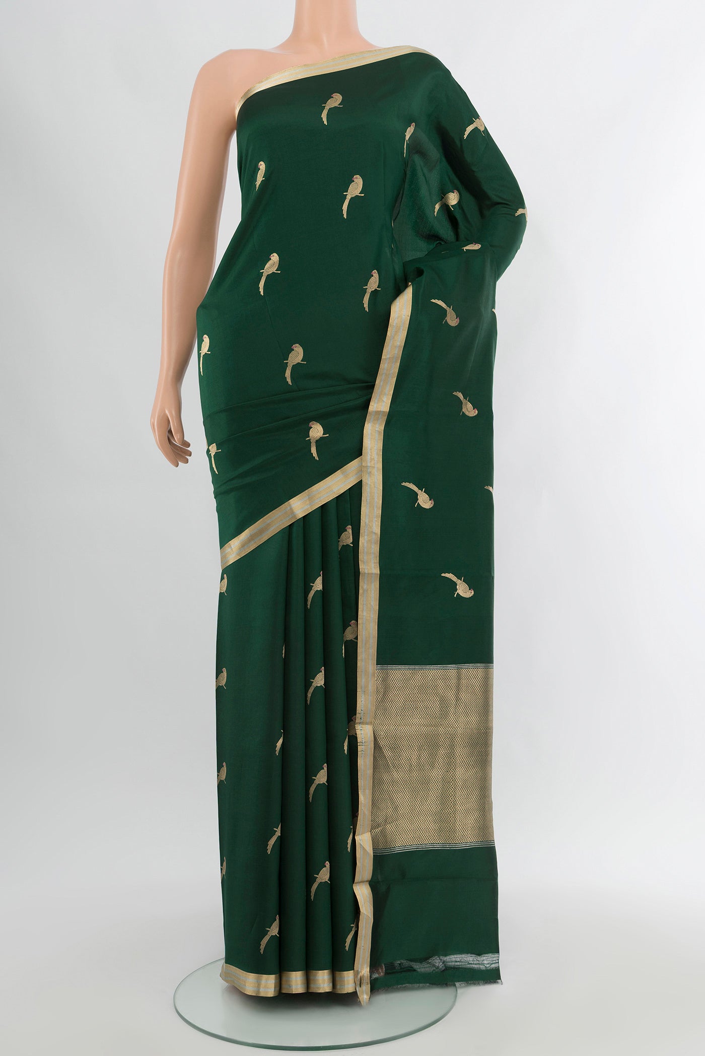 Bottle Green Banarasi Katan Silk Saree with Zari Butta on the body and Zari Border.  displayed on a mannequin