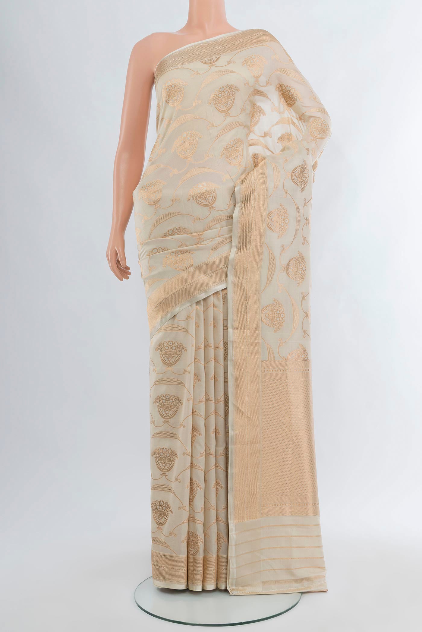 Cream Banarasi Silk Saree with Zari Butta on the body and Zari Border.  displayed on a mannequin