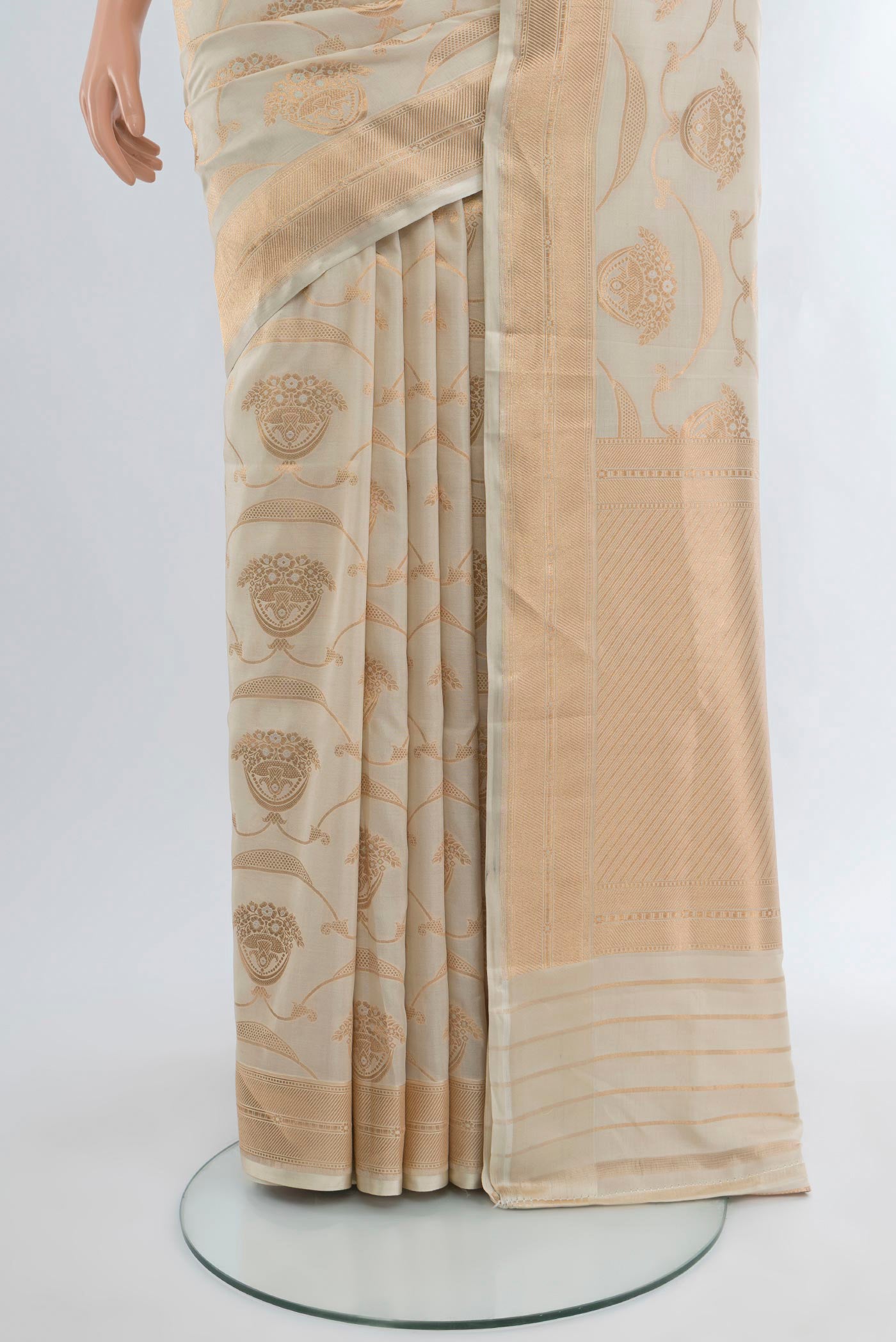 Pleats and pallu of Cream Banarasi Silk Saree with Zari Butta on the body and Zari Border. 