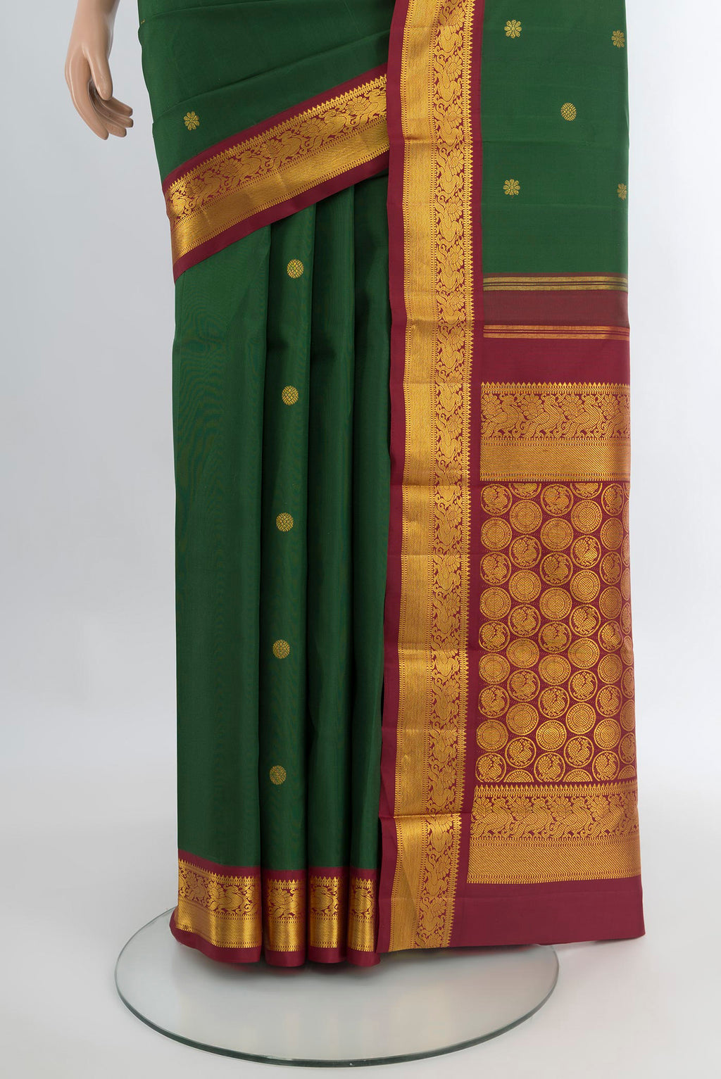 Pleats and pallu of Bottle Green Kanchipuram Silk Saree with Zari Butta on the body and Zari Border. 