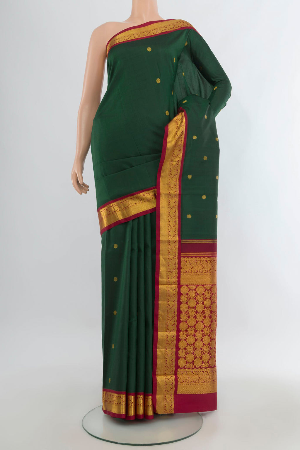 Pure Silk Bottle Green Kanchipuram Saree with Zari Butta on the body and Zari Border.  displayed on a mannequin