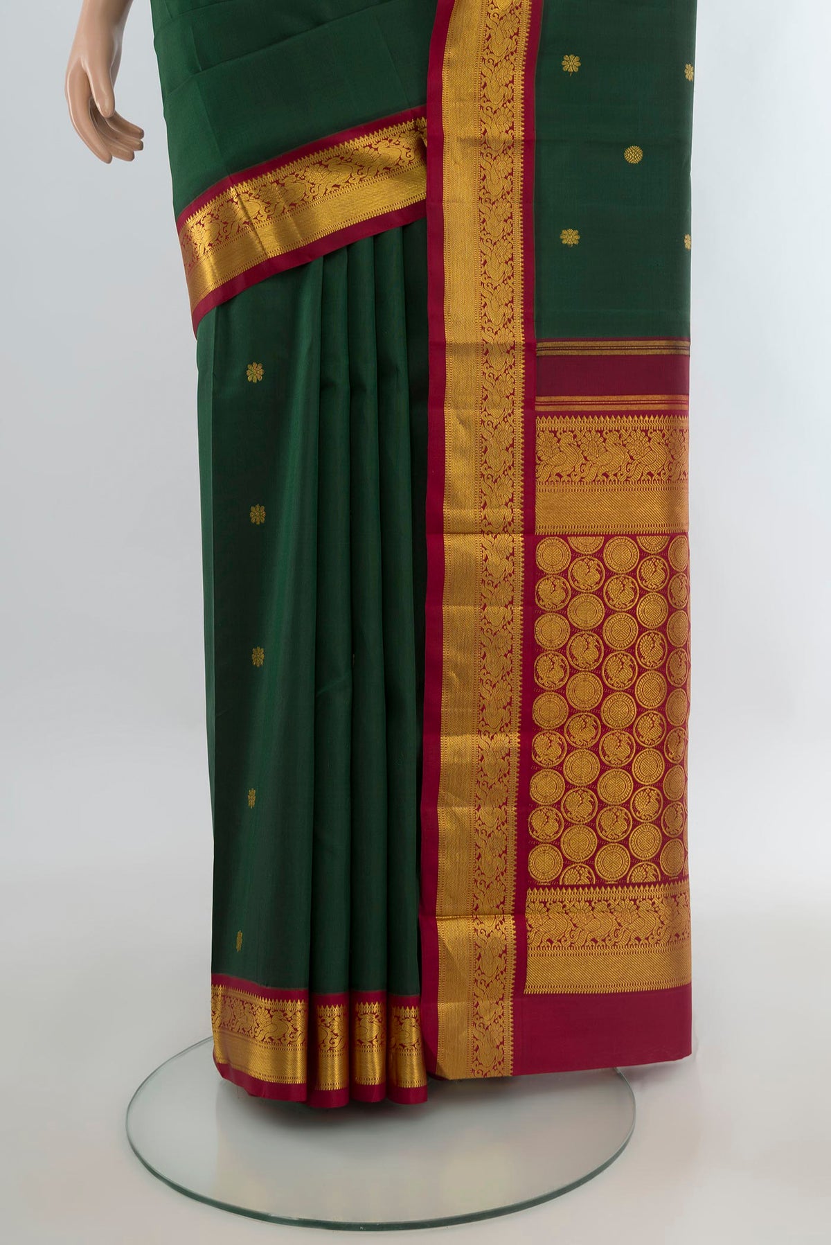 Pleats and pallu of Pure Silk Bottle Green Kanchipuram Saree with Zari Butta on the body and Zari Border. 