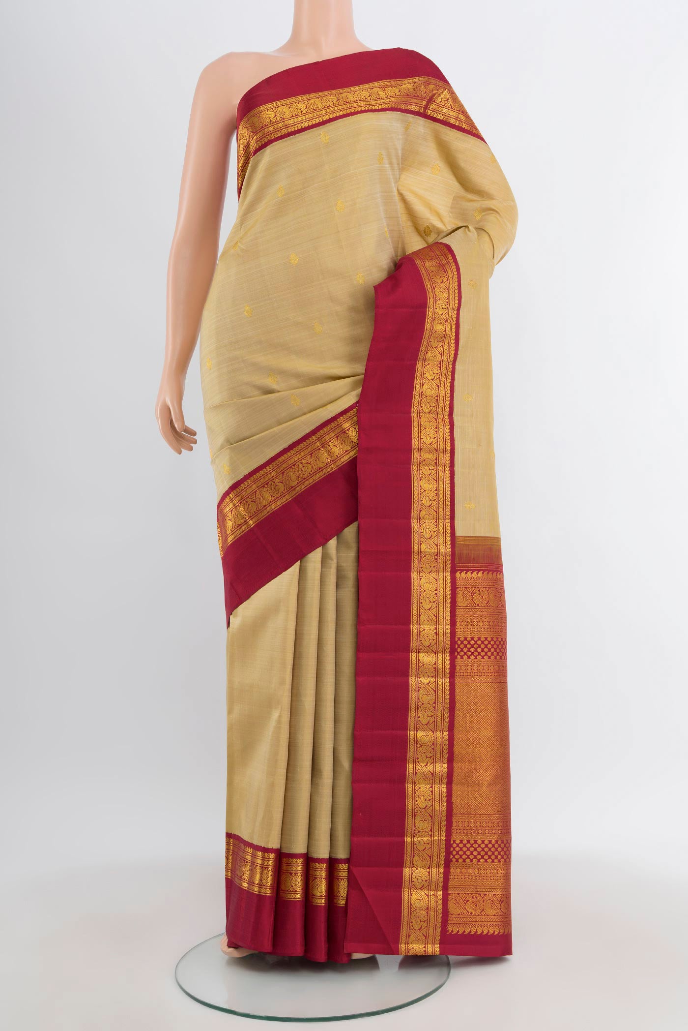 Pure Silk Pure Zari Sandal Kanchipuram Saree with Zari Butta on the body and Zari Border.  displayed on a mannequin